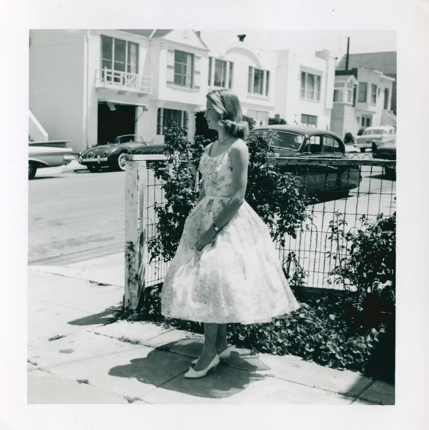 Young Woman in Floral Party Dress on Residential Sidewalk, Late 1950s/Early 1960s (Content Mismatch with Filed Collection)