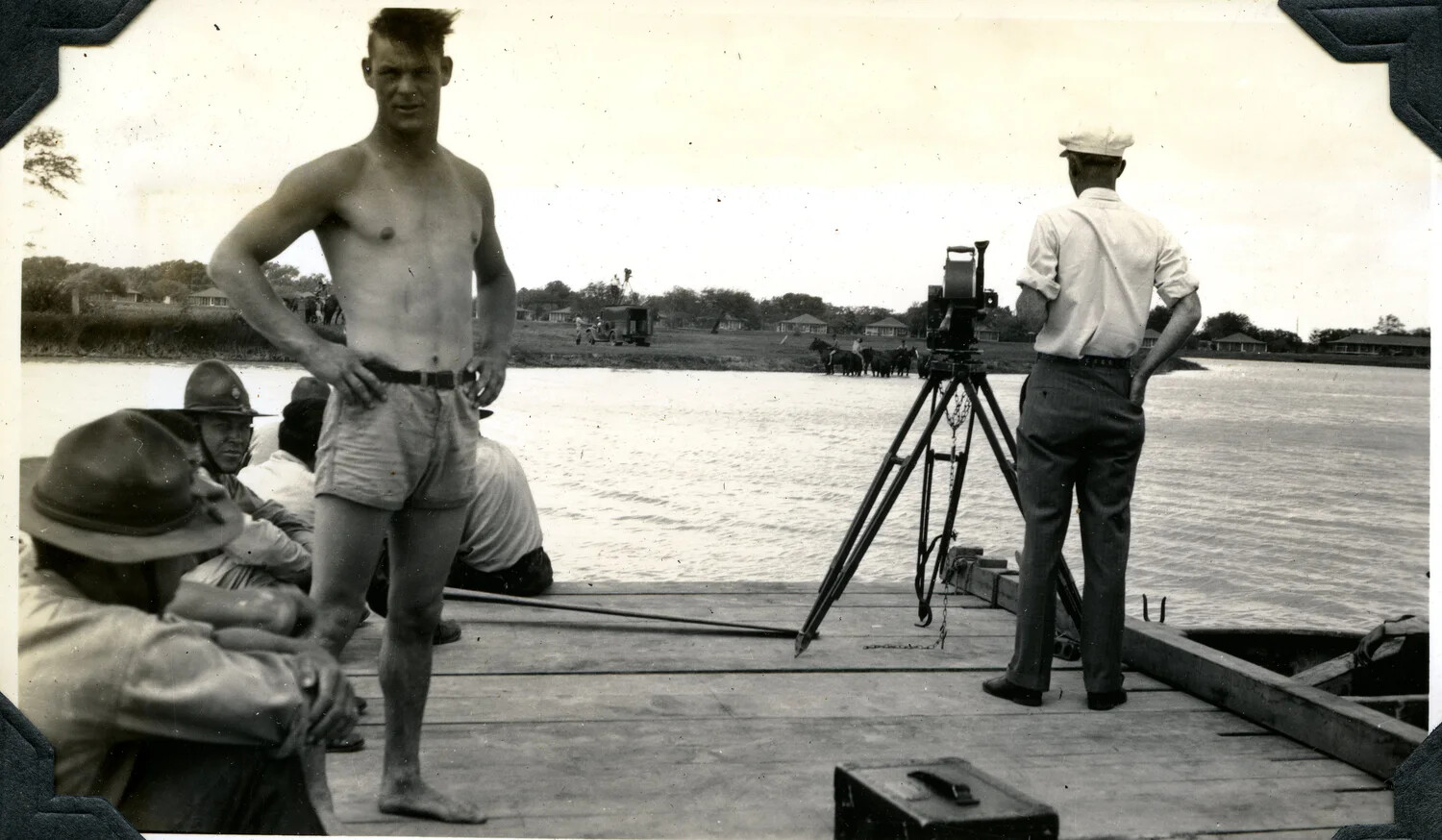 Signal Corps Cameraman Filming from a River Barge, with Off-Duty Soldiers