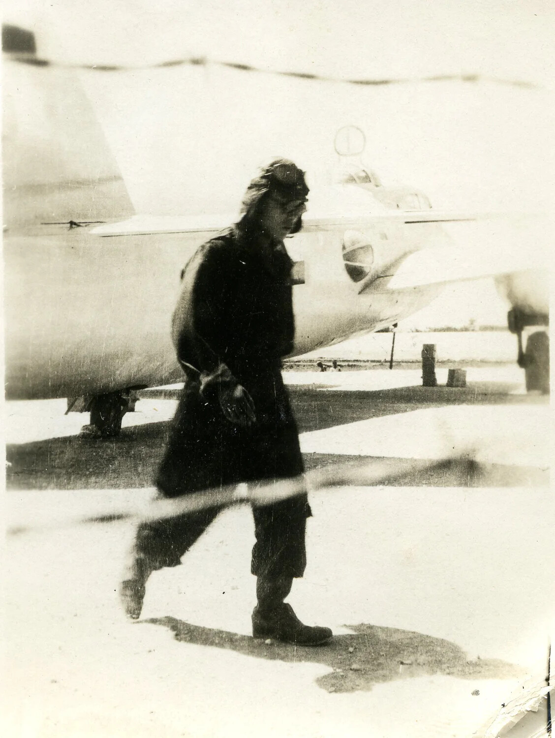 Figure in Flight Suit Walking Past Japanese 'Betty' Bomber, Ie Shima, August 1945