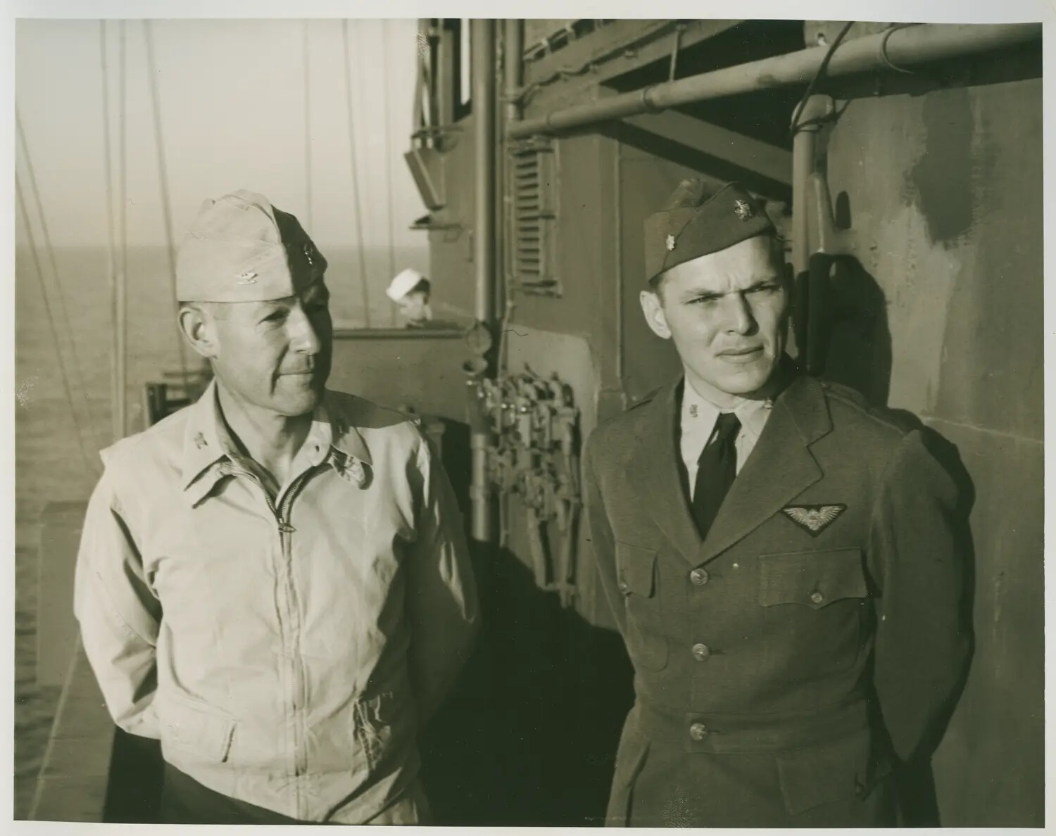 Two US Navy Officers on Deck, One Wearing Naval Aviator Wings – USS Petrof Bay