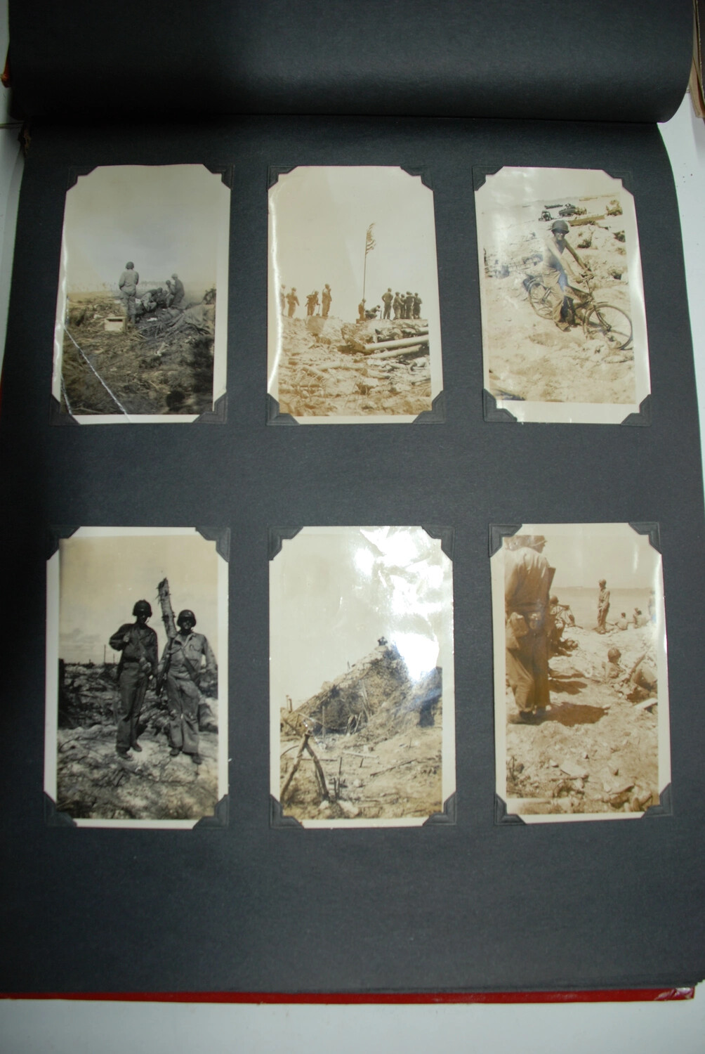 Album Page of Six Combat Snapshots (Full View) -- Flag Raising, Beach Bicycle, and Infantry with Bazooka, Jack T. Kelley Album