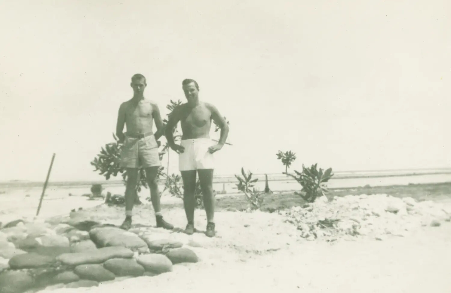 Servicemen on Pacific Atoll Beach Near Sandbag Position, Edward P. McAleer Collection, WWII