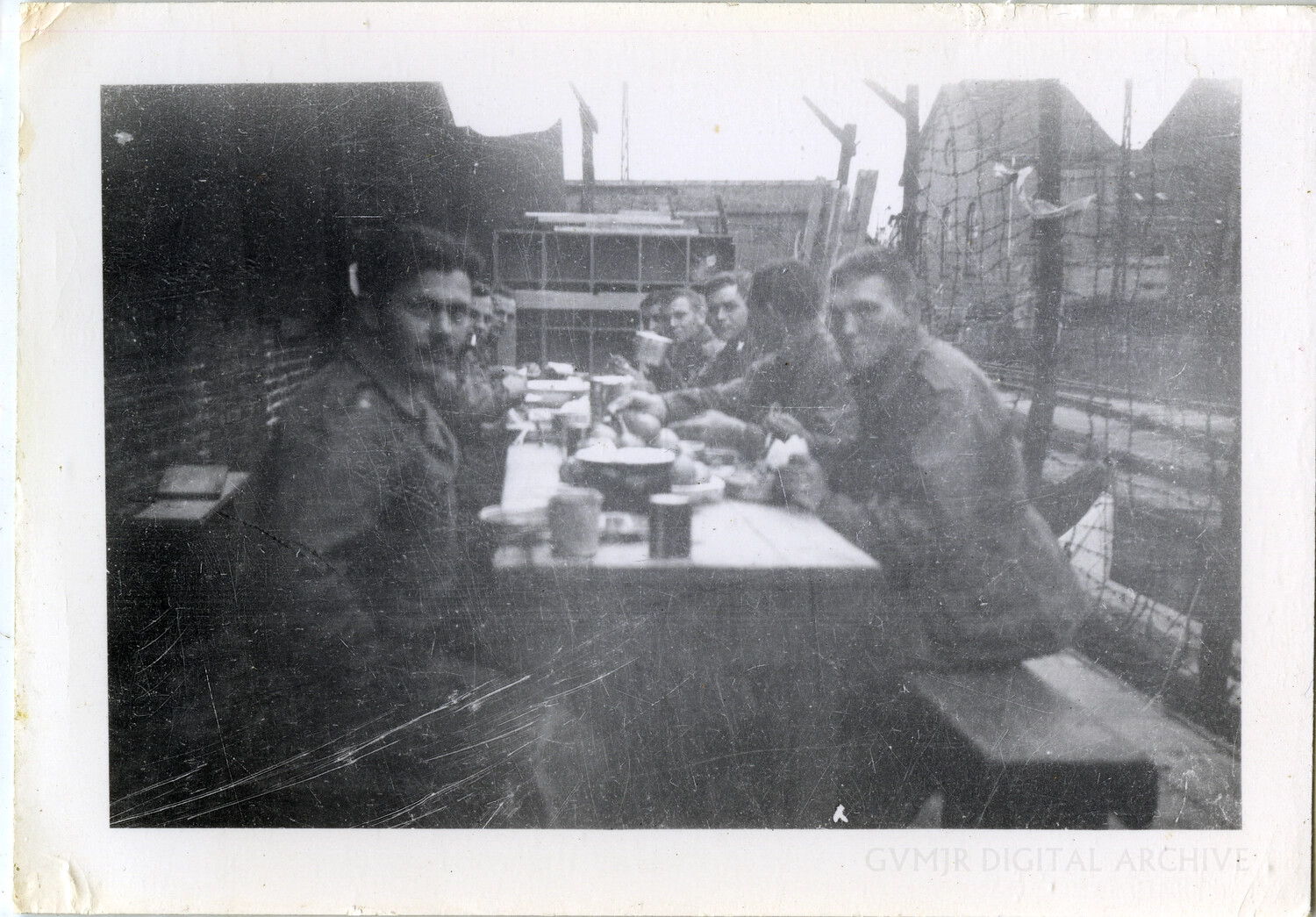GIs Sharing a Field Mess Behind Camp Perimeter Wire, WWII European Theater