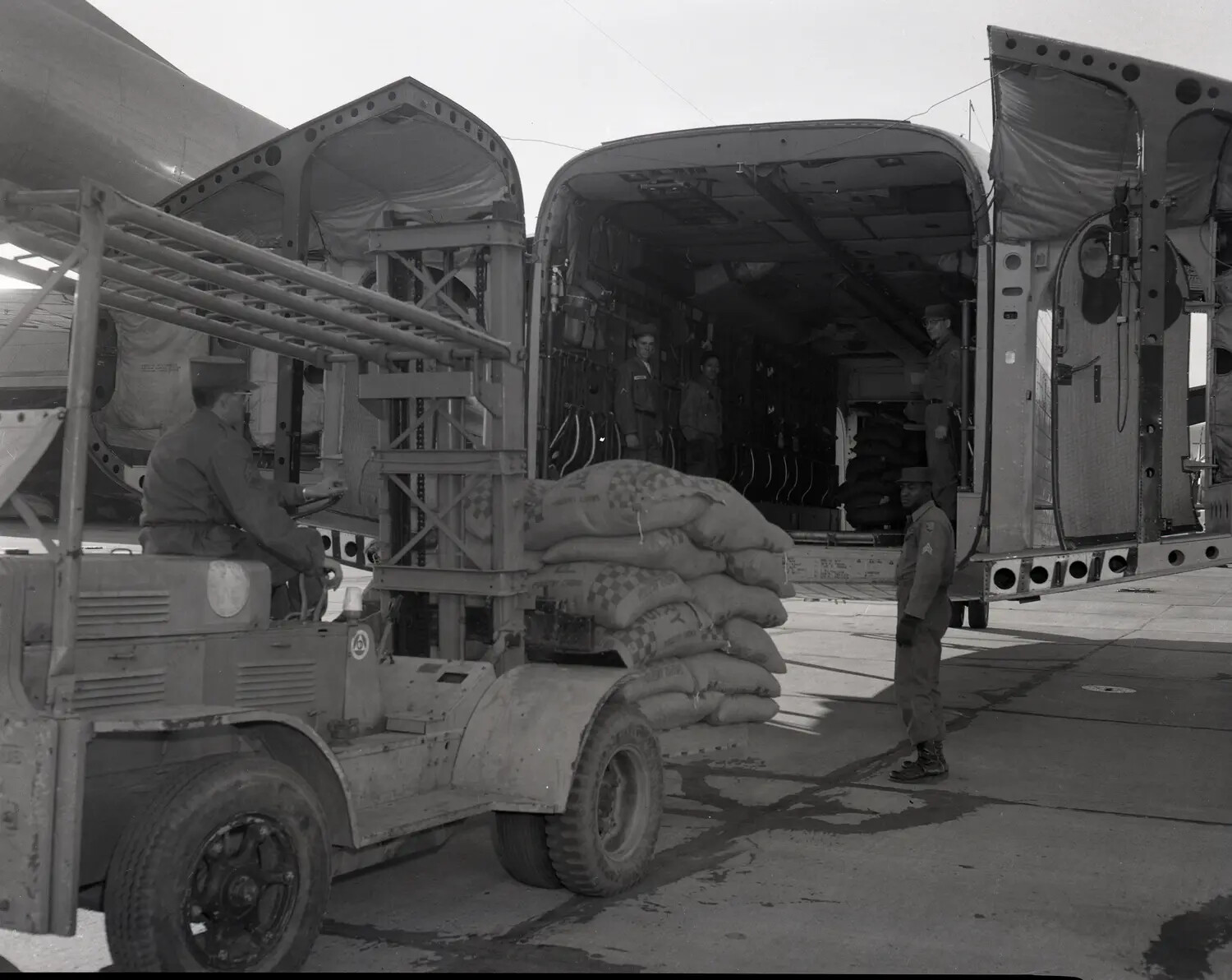 Forklift Loading Cargo Aboard C-130 Hercules Transport Aircraft