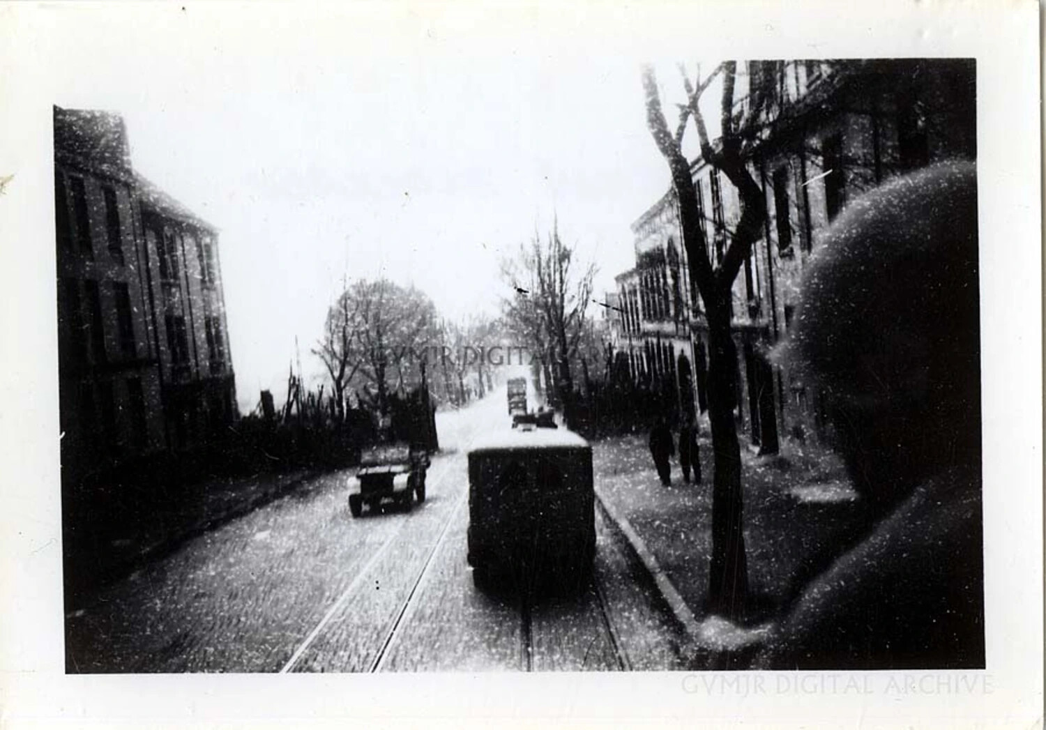 Snow-Covered European Street Scene Photographed from a Moving Army Vehicle