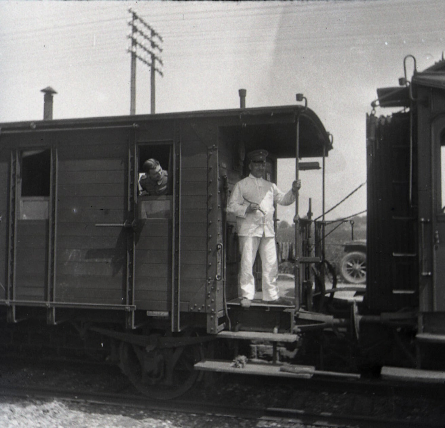 Uniformed Man on Railway Guard's Van Platform, WWI-Era Germany