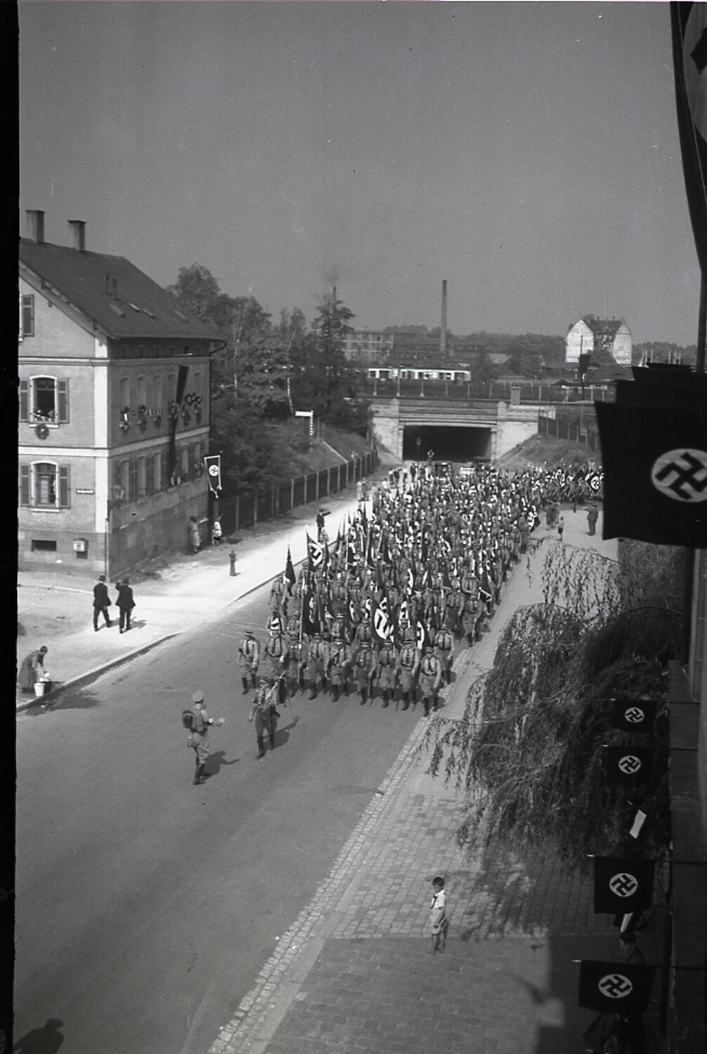 Nazi Party Formation Marching Through a German Town Street, 1930s