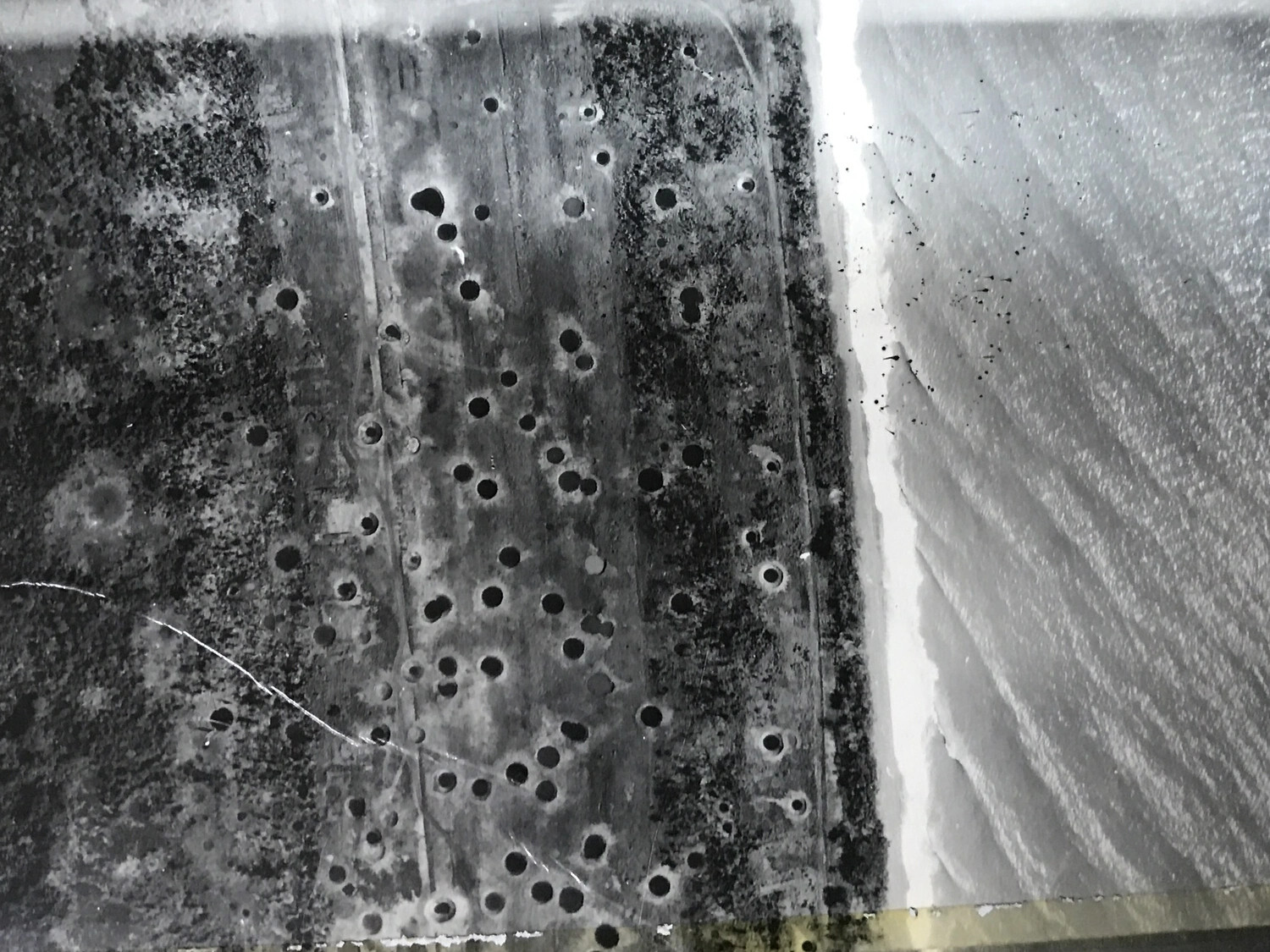 Vertical Aerial Reconnaissance Photograph: Bomb-Cratered Coastal Airstrip