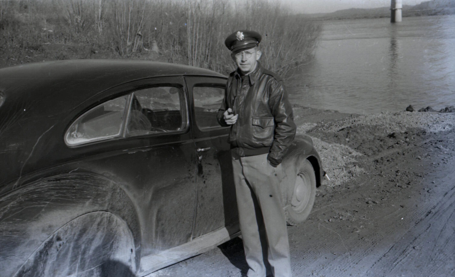 U.S. Officer Beside Sedan on Riverbank, China-Burma-India Theater, WWII