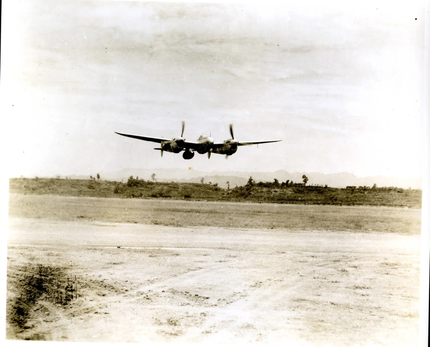 P-38 Lightning Fighter in Flight Over Forward Airfield, CBI Theater, World War II