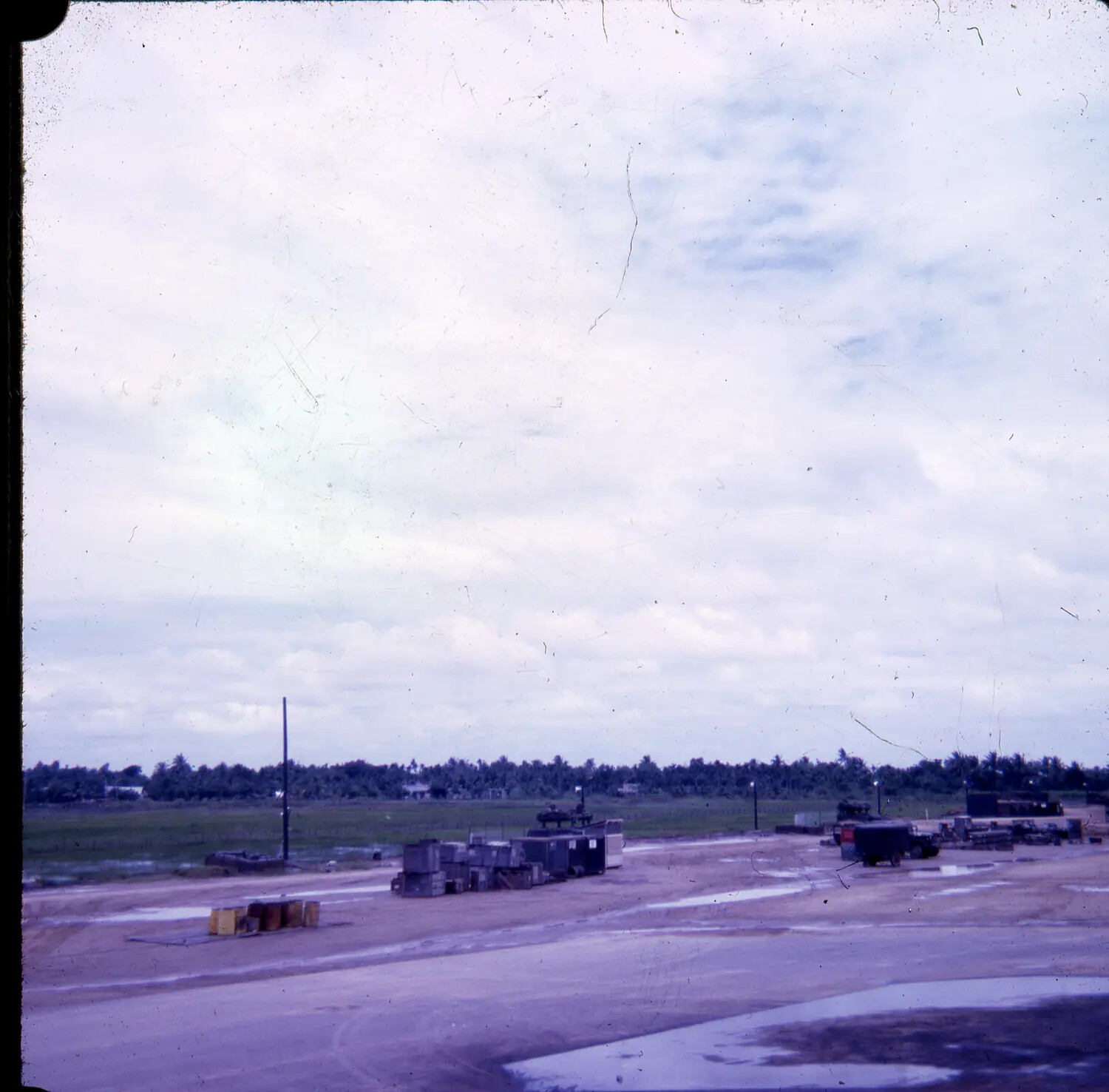 Support Yard with Ordnance Crates and Vehicles at U.S. Base, Vietnam War Era