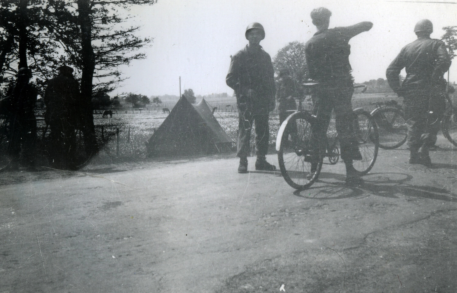 American Soldiers and Local Civilians with Bicycles on a Country Road, European Theater