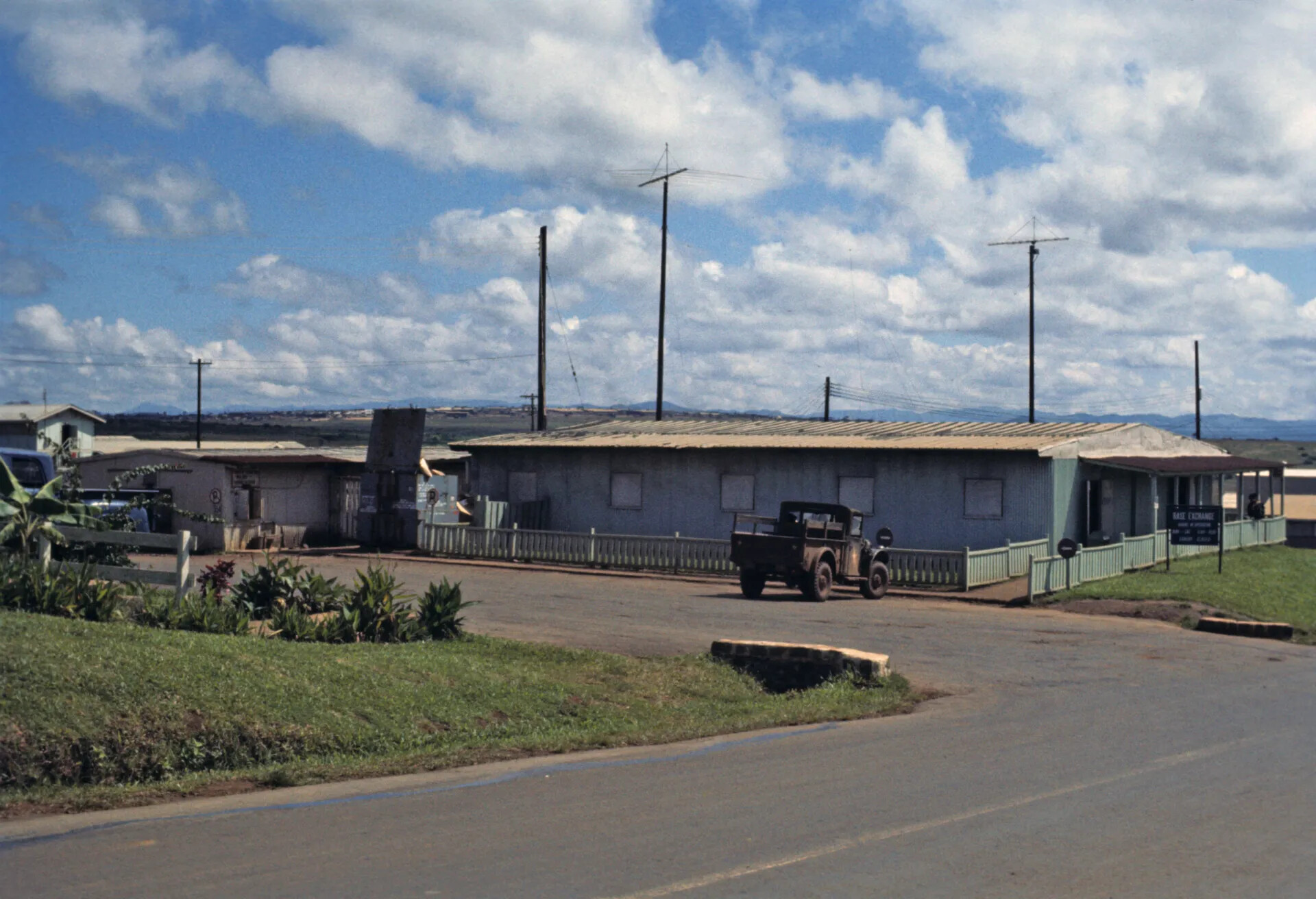 Base Exchange Building With Antennas and Parked Truck