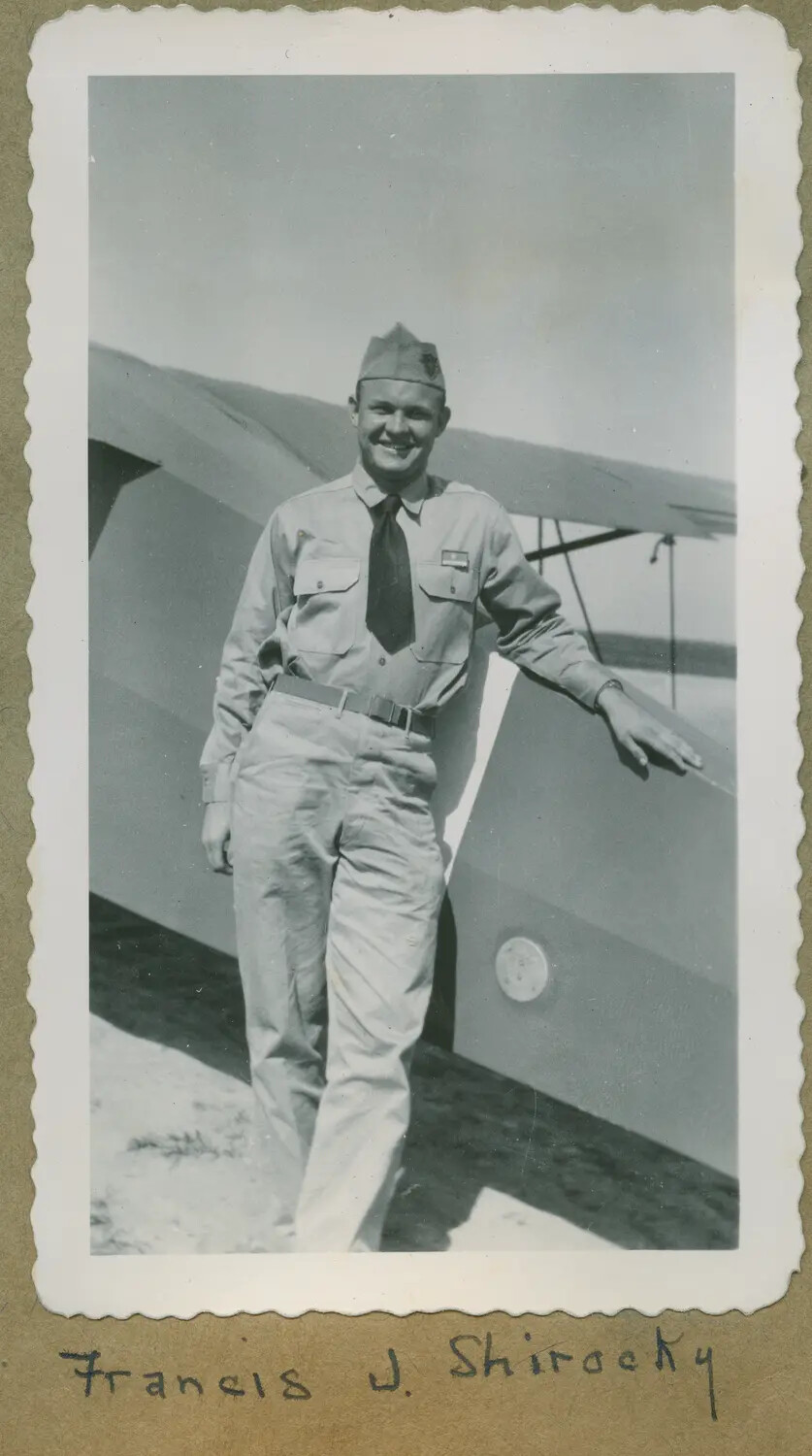 Francis J. Shirocky in Khaki Service Uniform Beside a Light Training Aircraft