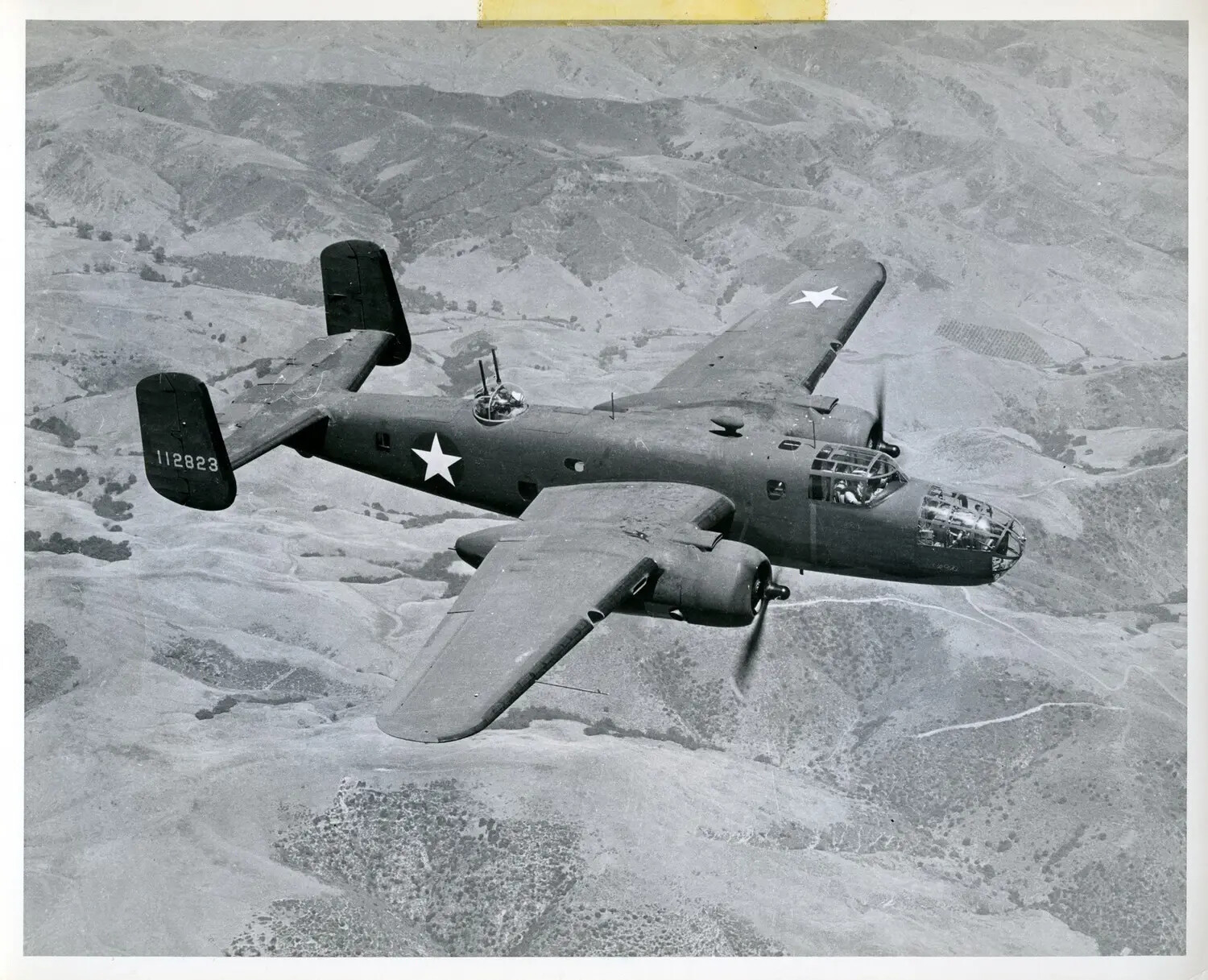 North American B-25 Mitchell Medium Bomber (Serial 112823) in Flight Over Mountainous Terrain