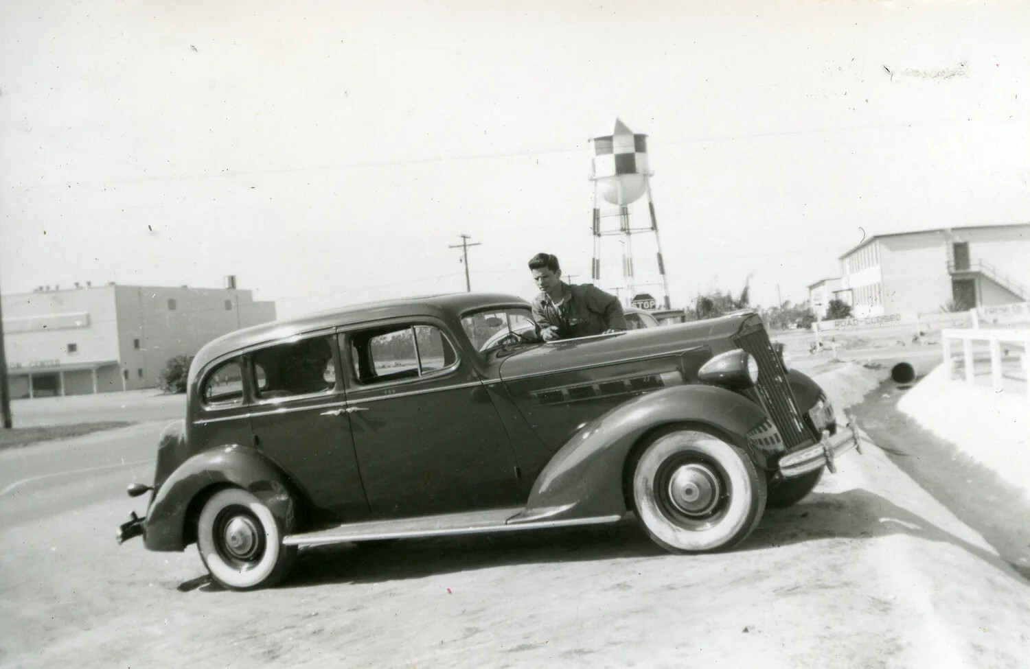 Marine in Service Jacket Beside Parked Sedan at U.S. Air Station, VMF-214 Photo Album, WWII Era
