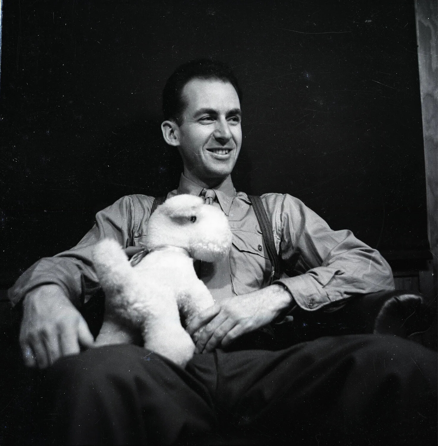Candid Portrait of a Young Man Holding a Stuffed Toy Lamb
