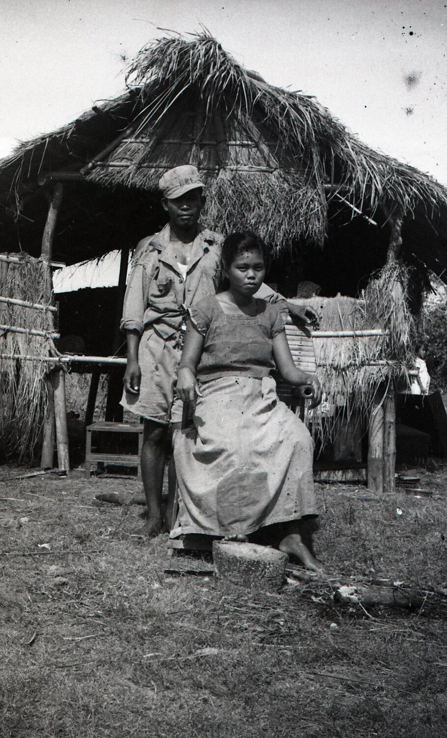 Filipino Man and Woman Before a Nipa Hut, Luzon, Philippines, World War II Era
