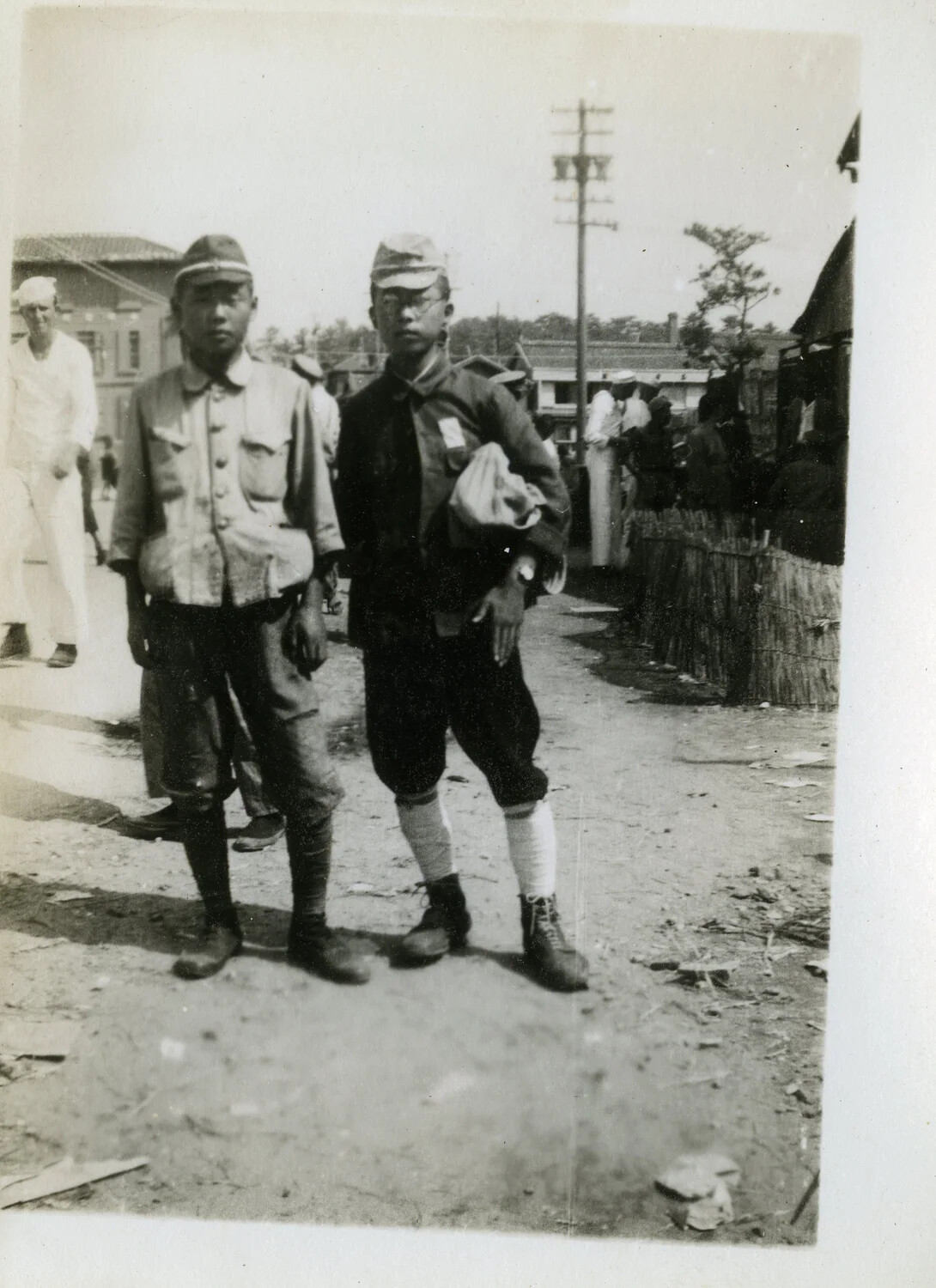 Japanese Youths in School/Cadet Uniform with American Serviceman in Background, Occupied Japan, Post-WWII