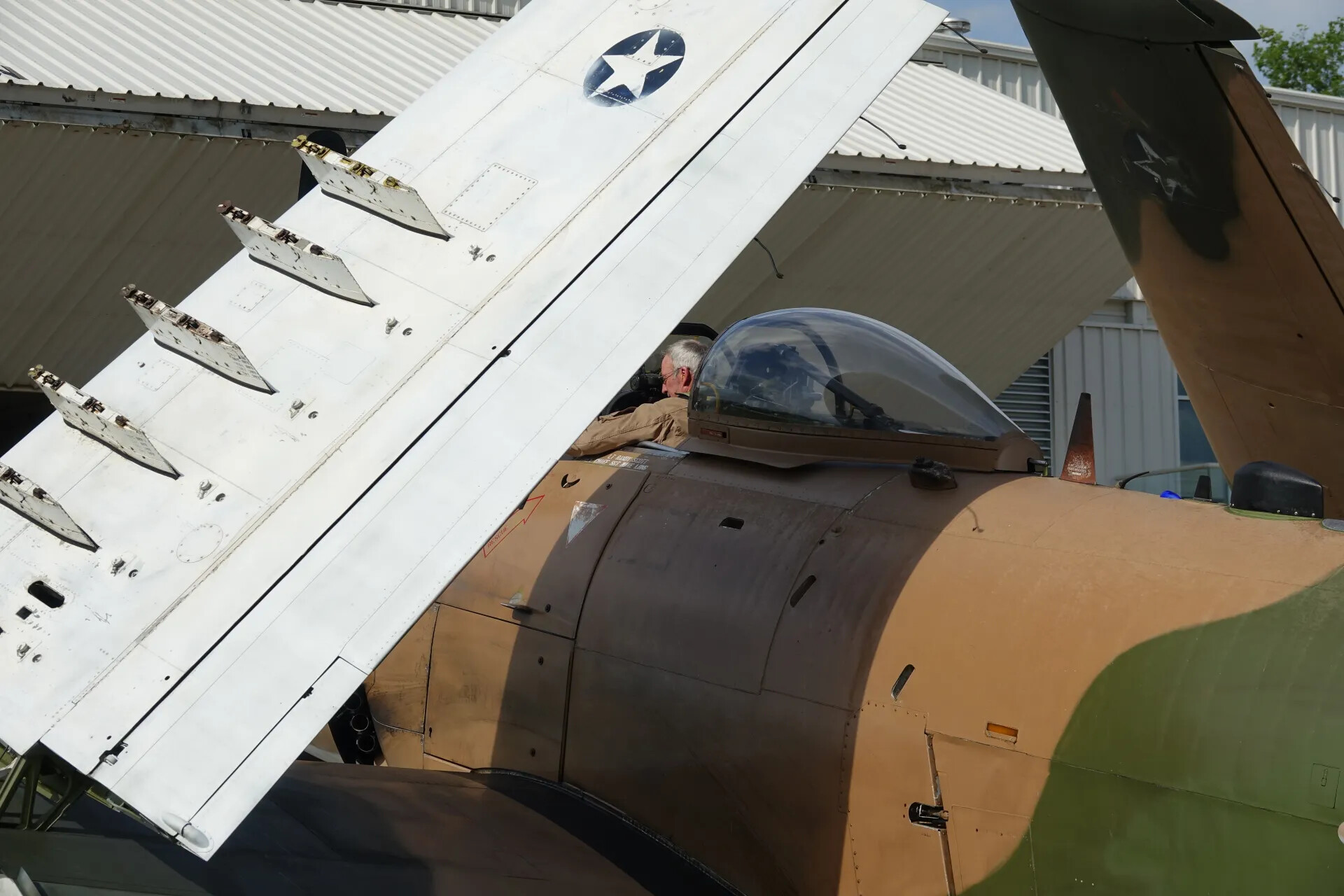 Douglas A-1 Skyraider Folded Wing Panel Detail with Second Aircraft and Hangar Beyond