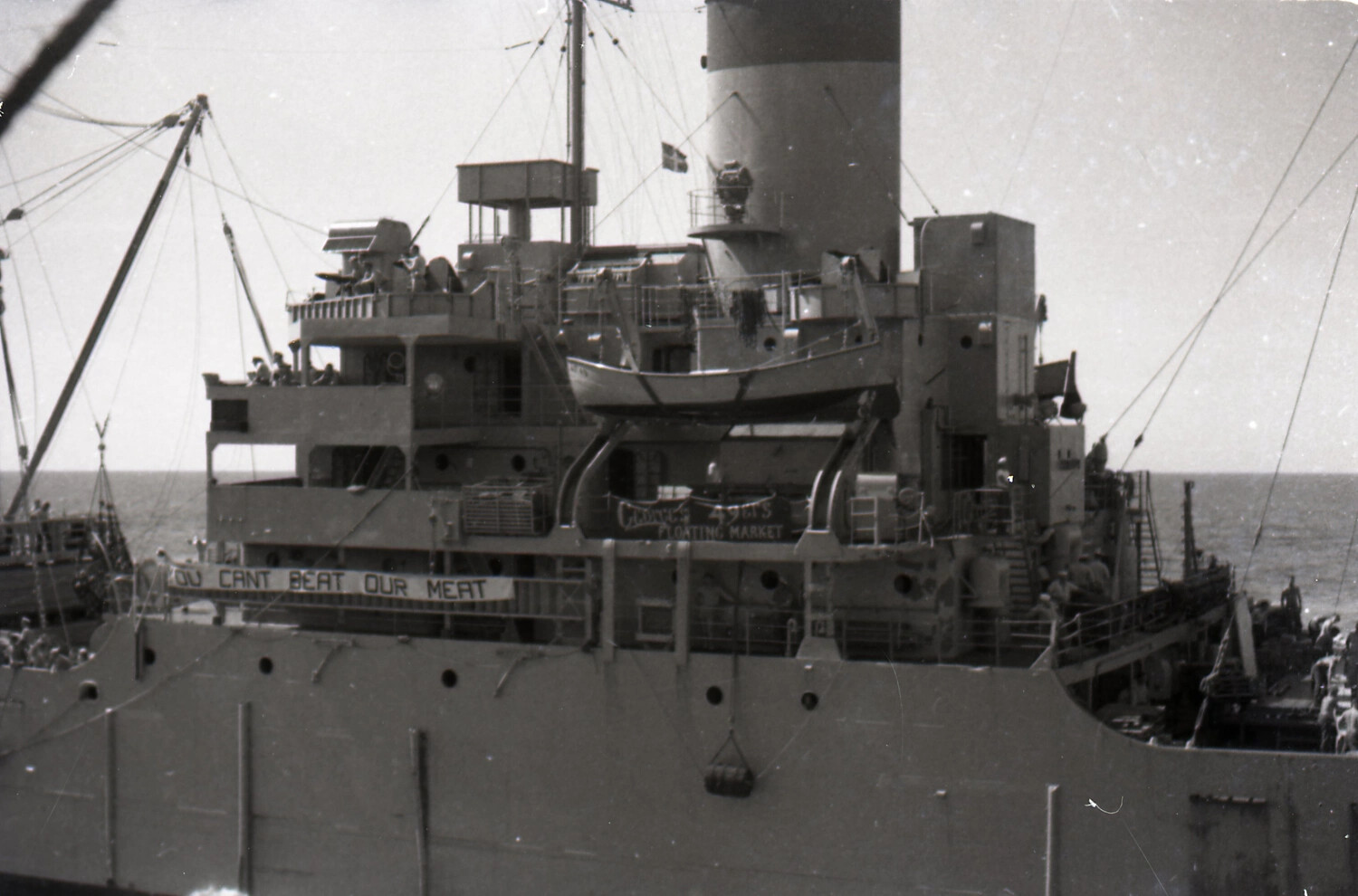 USS Zelima (AF-49) Alongside During Underway Replenishment, with Humorous Deck Banners