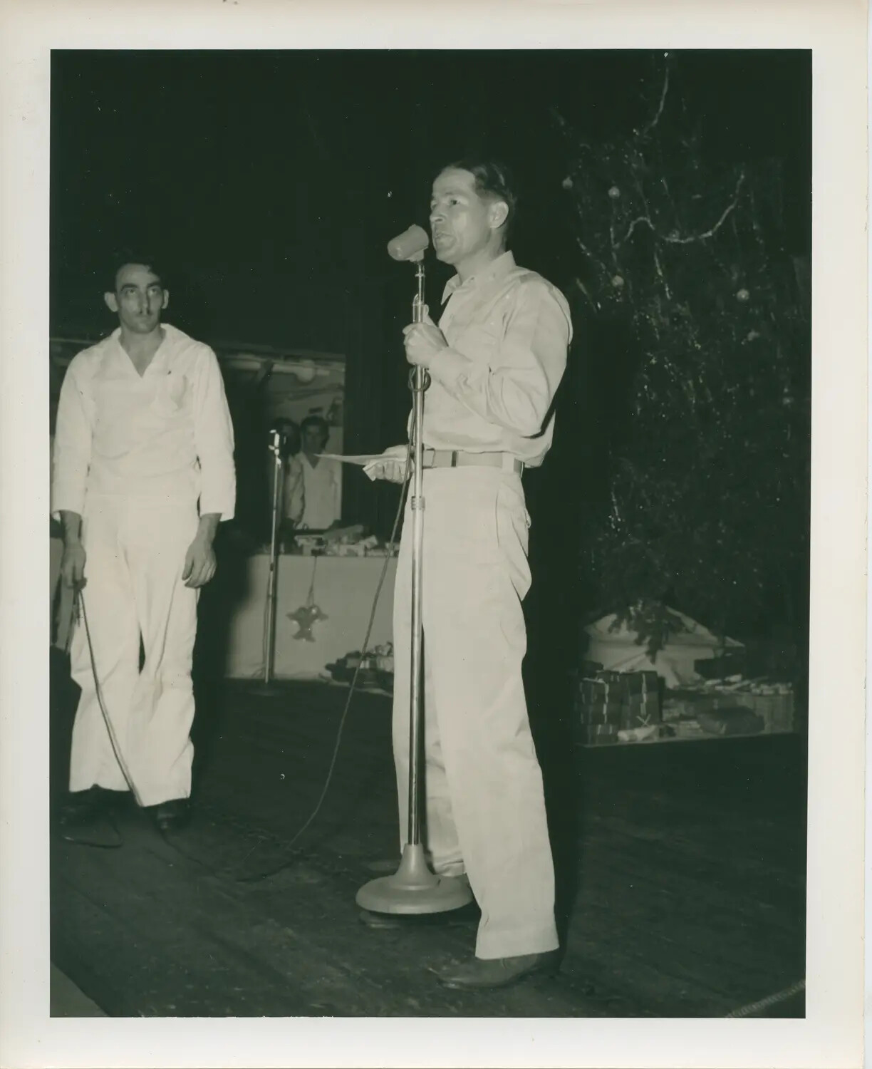 Sailor Addressing Crew at Shipboard Christmas Program, USS Petrof Bay (CVE-80)