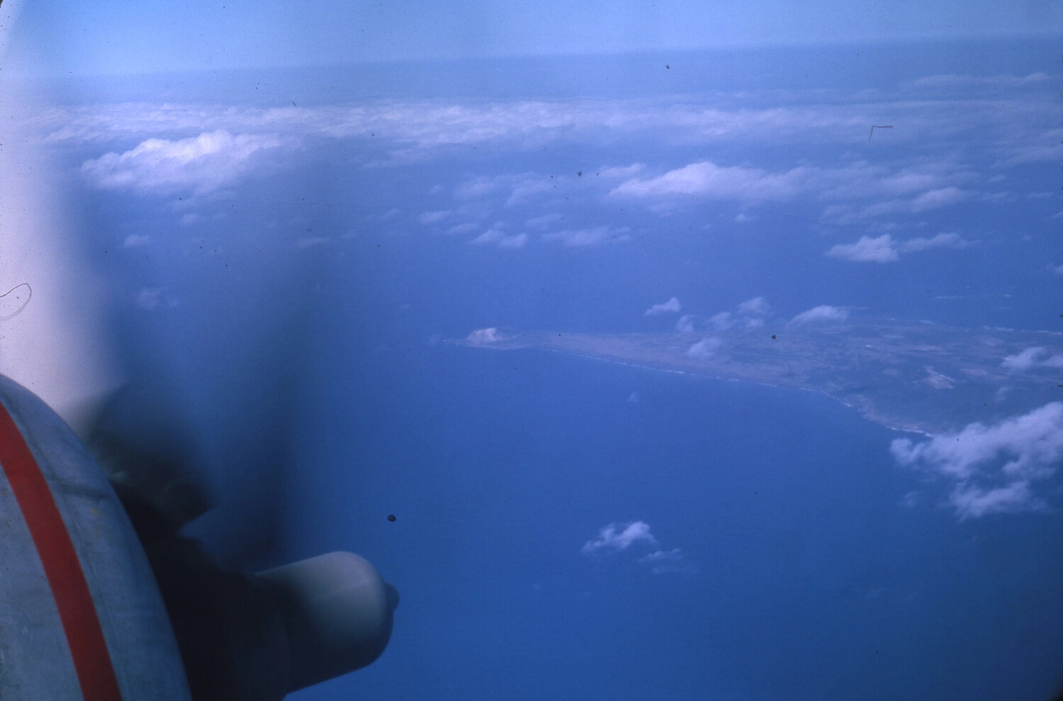 Aerial View of Vietnamese Coastline from Aircraft Window, with Spinning Propeller in Foreground - Vietnam War Era