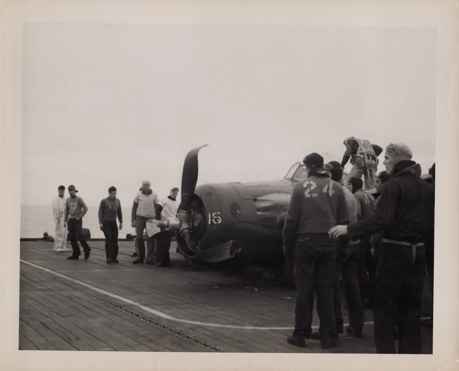 WWII U.S. Navy Escort Carrier Flight Deck Scene with Aircraft and Deck Crew (Vessel Identity Uncertain, Likely Not Petrof Bay)