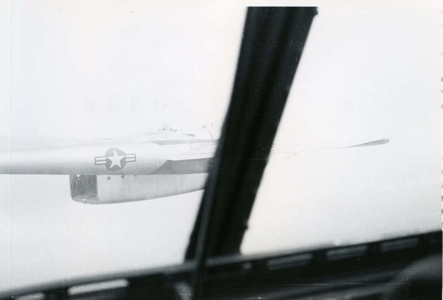 In-Flight View of Formation Aircraft Wing Through Cockpit Window