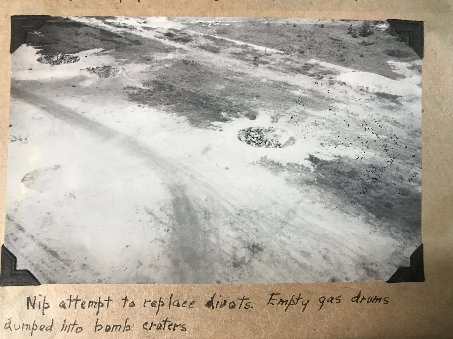 Aerial Reconnaissance Photograph of Bomb-Damaged Airfield with Japanese Repair Efforts, Southwest Pacific Theater, WWII