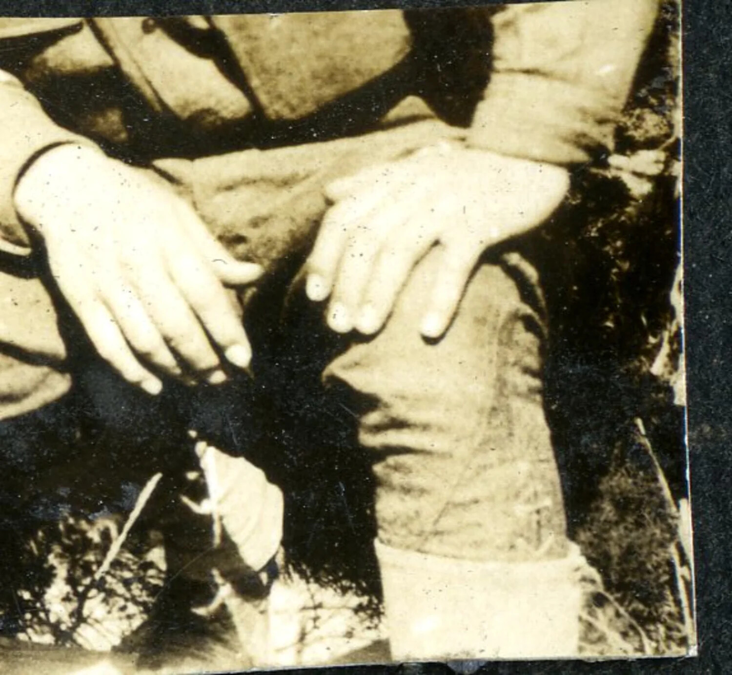 Close-Up Detail of Hands and Puttee-Wrapped Leg, WWI-Era Snapshot