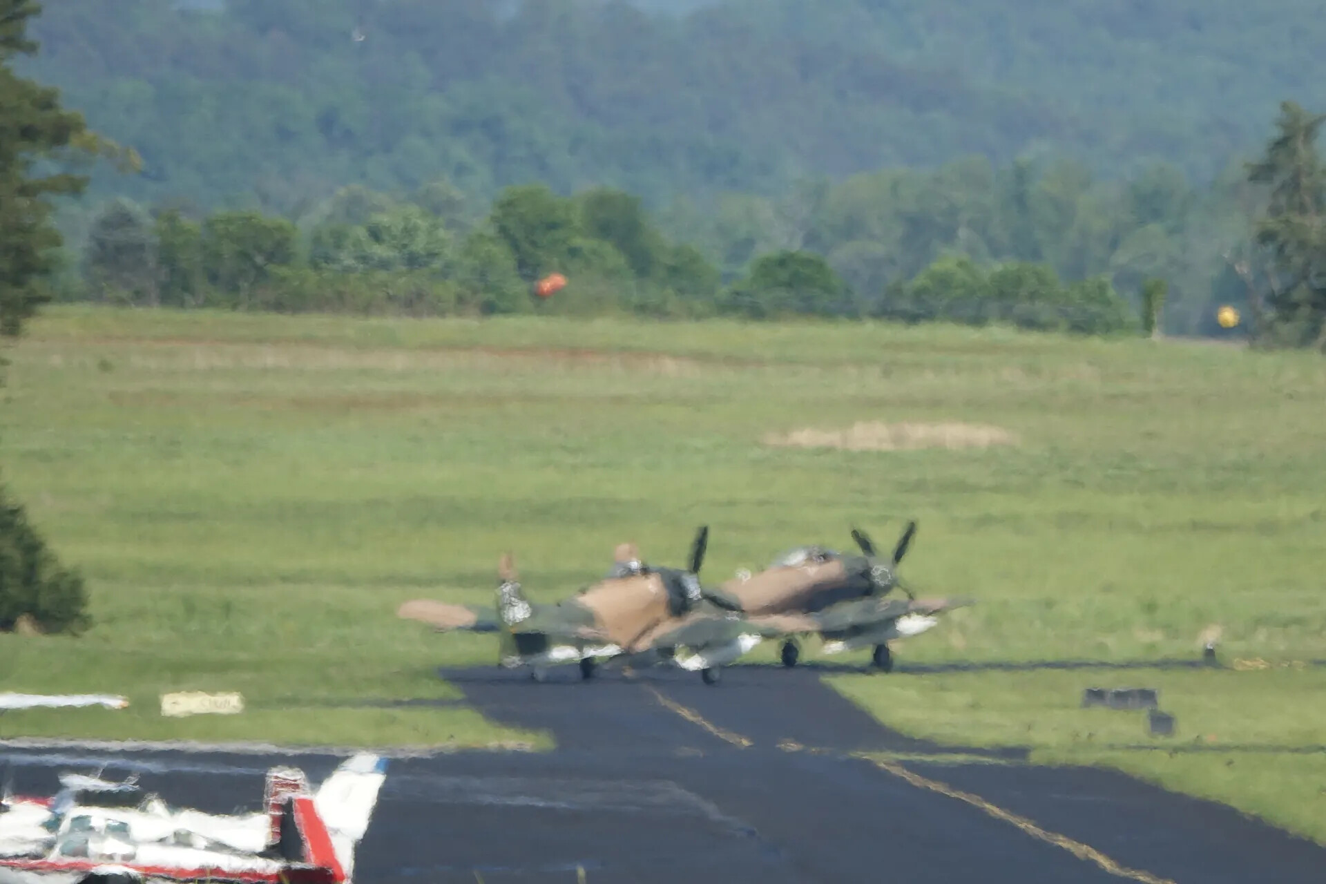 Two Camouflaged Radial-Engine Attack Aircraft Taxiing at Warbird Fly-In Event, May 2019