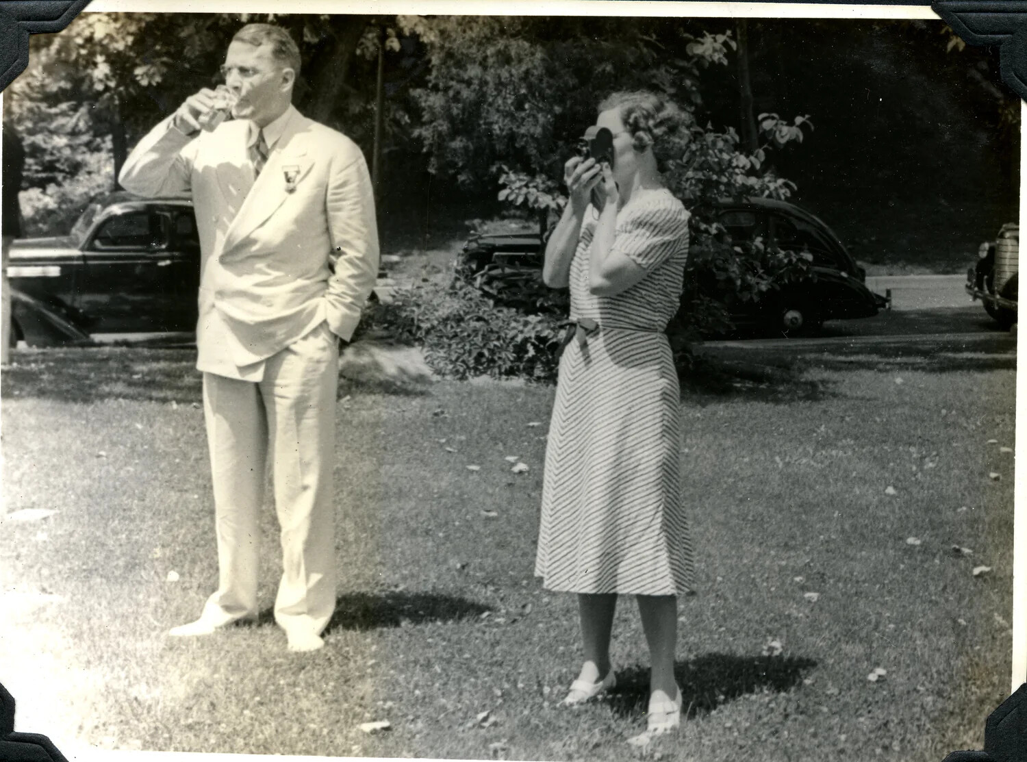 Man and Woman on Lawn, Woman Photographing with Box Camera, c. late 1930s