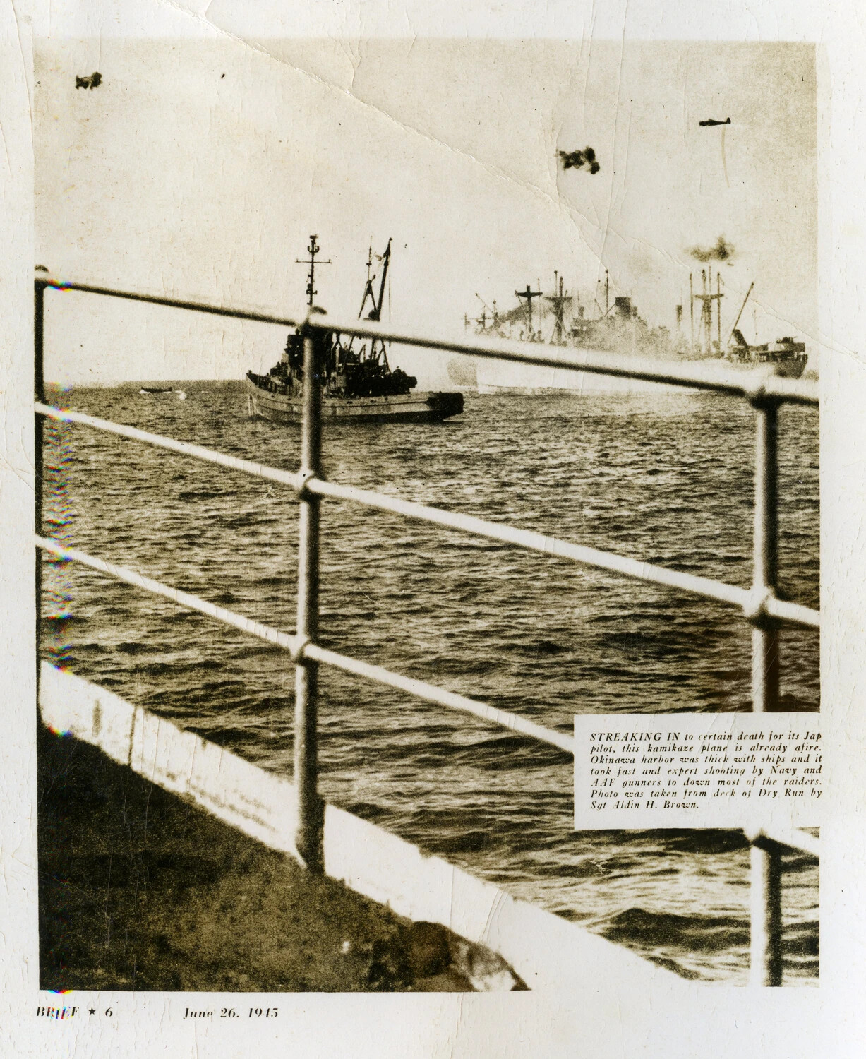 Kamikaze Plane Afire Over Okinawa Harbor, Photographed from USAAF Repair Ship Dry Run, June 1945