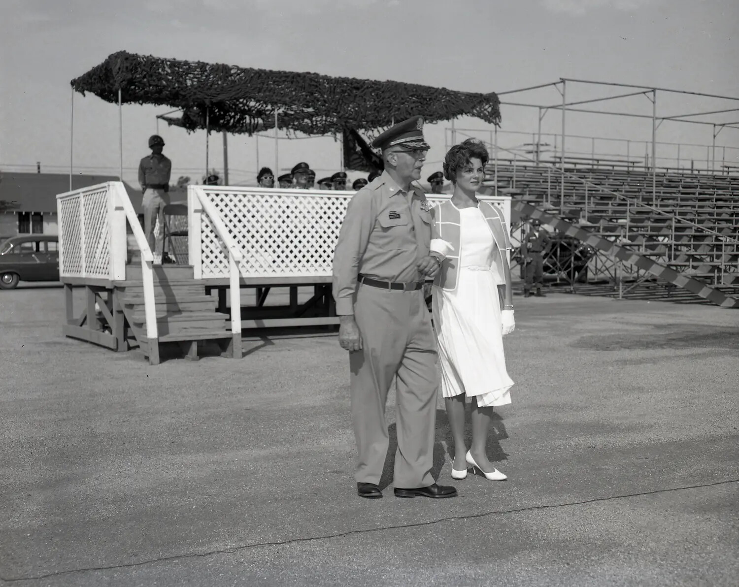 Miss California Escorted by Senior Officer Past Reviewing Stand, National Guard Encampment, July 1960