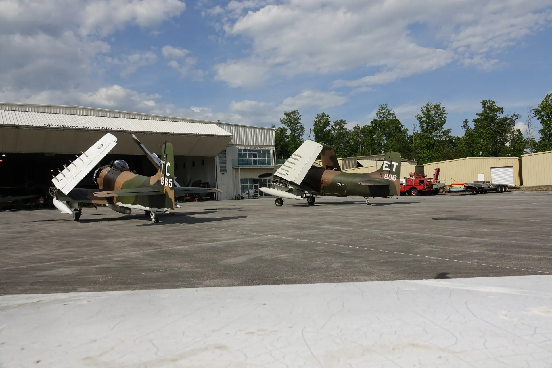 Two Douglas A-1 Skyraiders, Wings Folded, Parked at Museum Hangar
