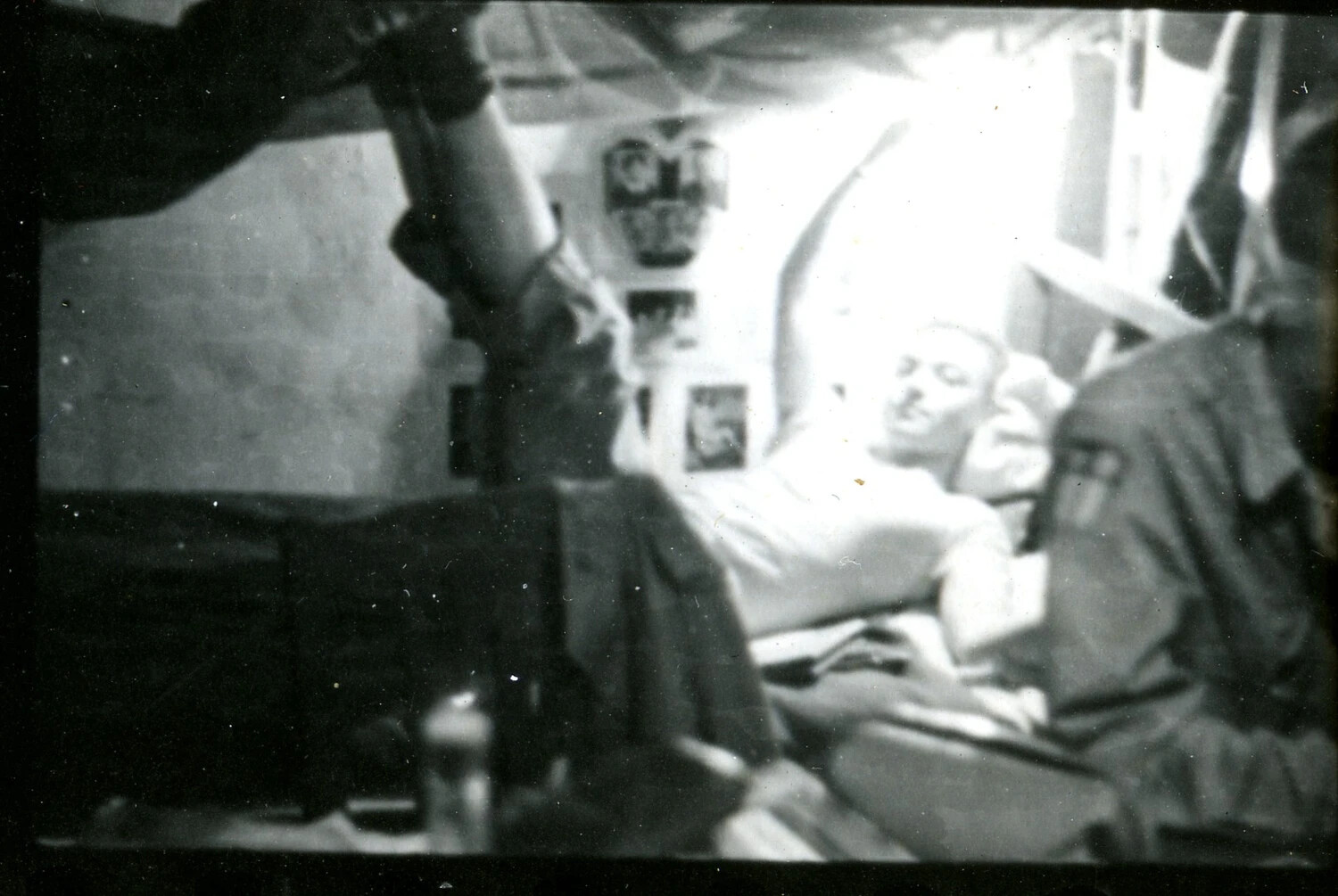 Barracks Interior with Resting Serviceman and Pin-Up Photos, CBI Theater, WWII (Blurred Snapshot)