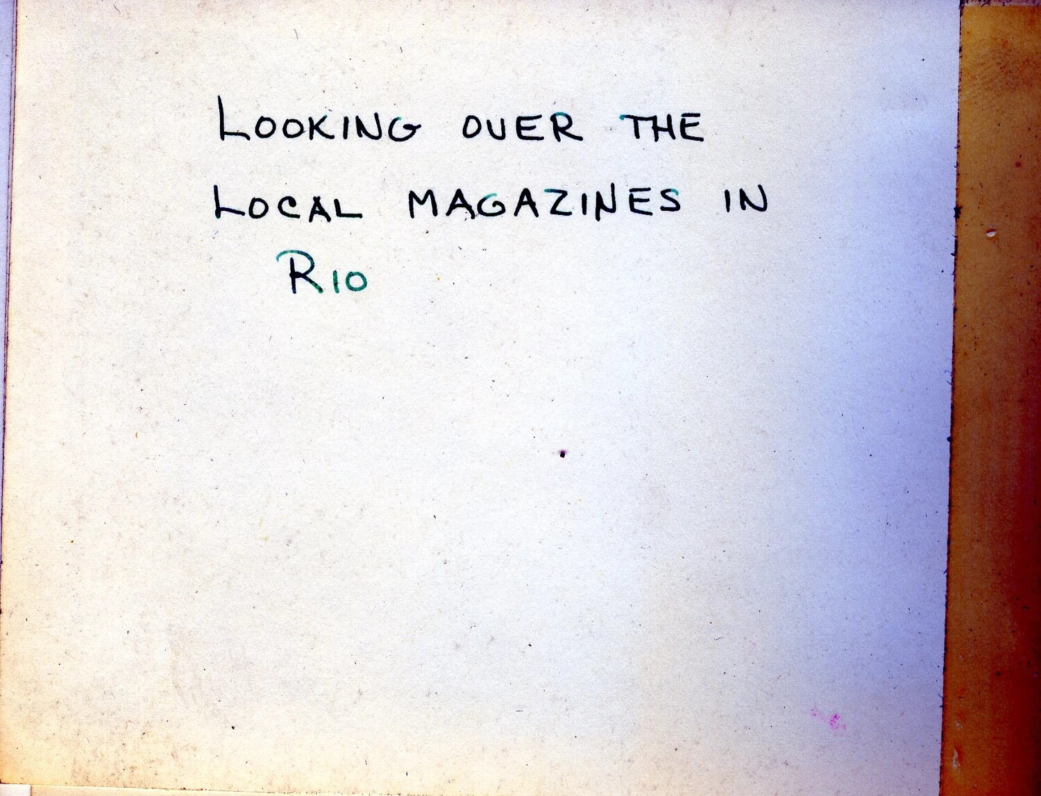 Photo Album Caption Page: 'Looking Over the Local Magazines in Rio' — USS Franklin D. Roosevelt (CVB-42) Cruise Album
