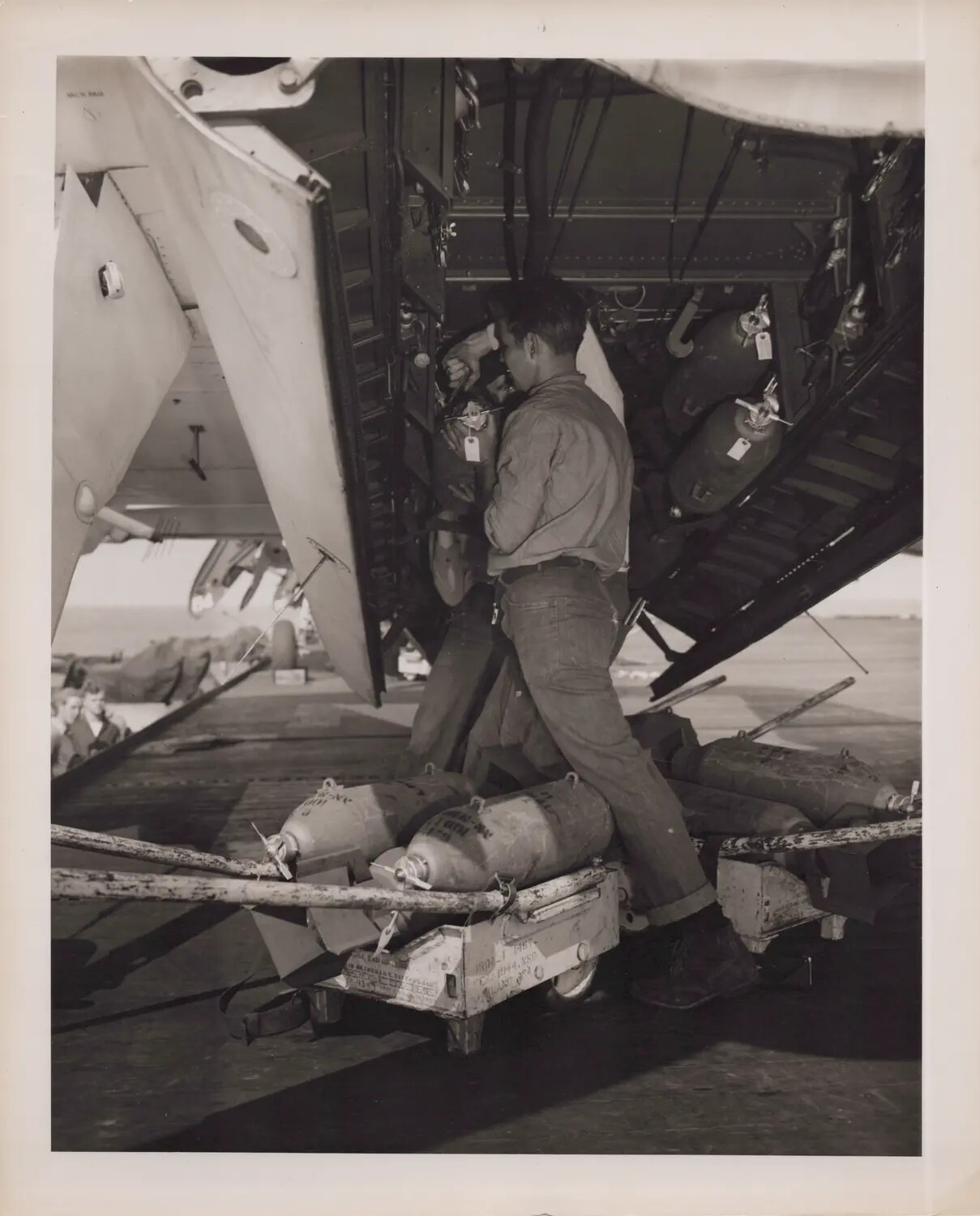 Navy Ordnanceman Loading Bombs into Aircraft Bomb Bay, Escort Carrier Flight Deck (WWII)