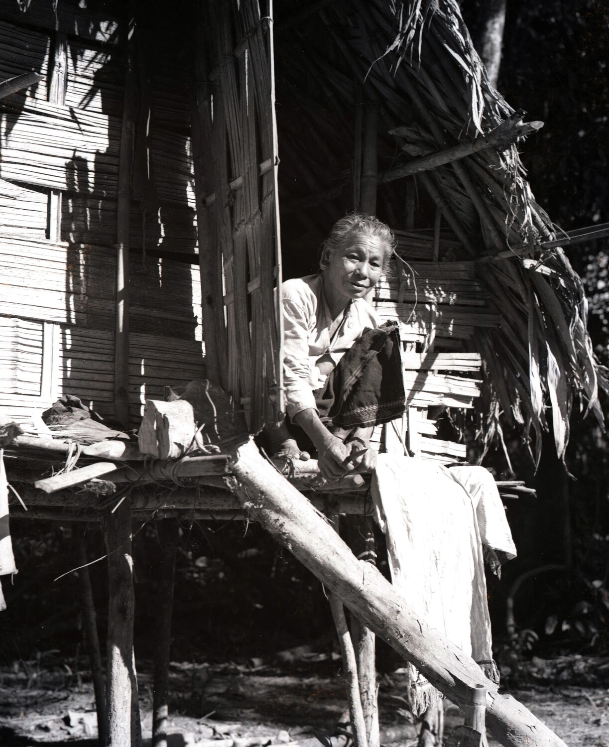 Elderly Burmese Woman at Traditional Bamboo Stilt House — CBI Theater WWII Photograph