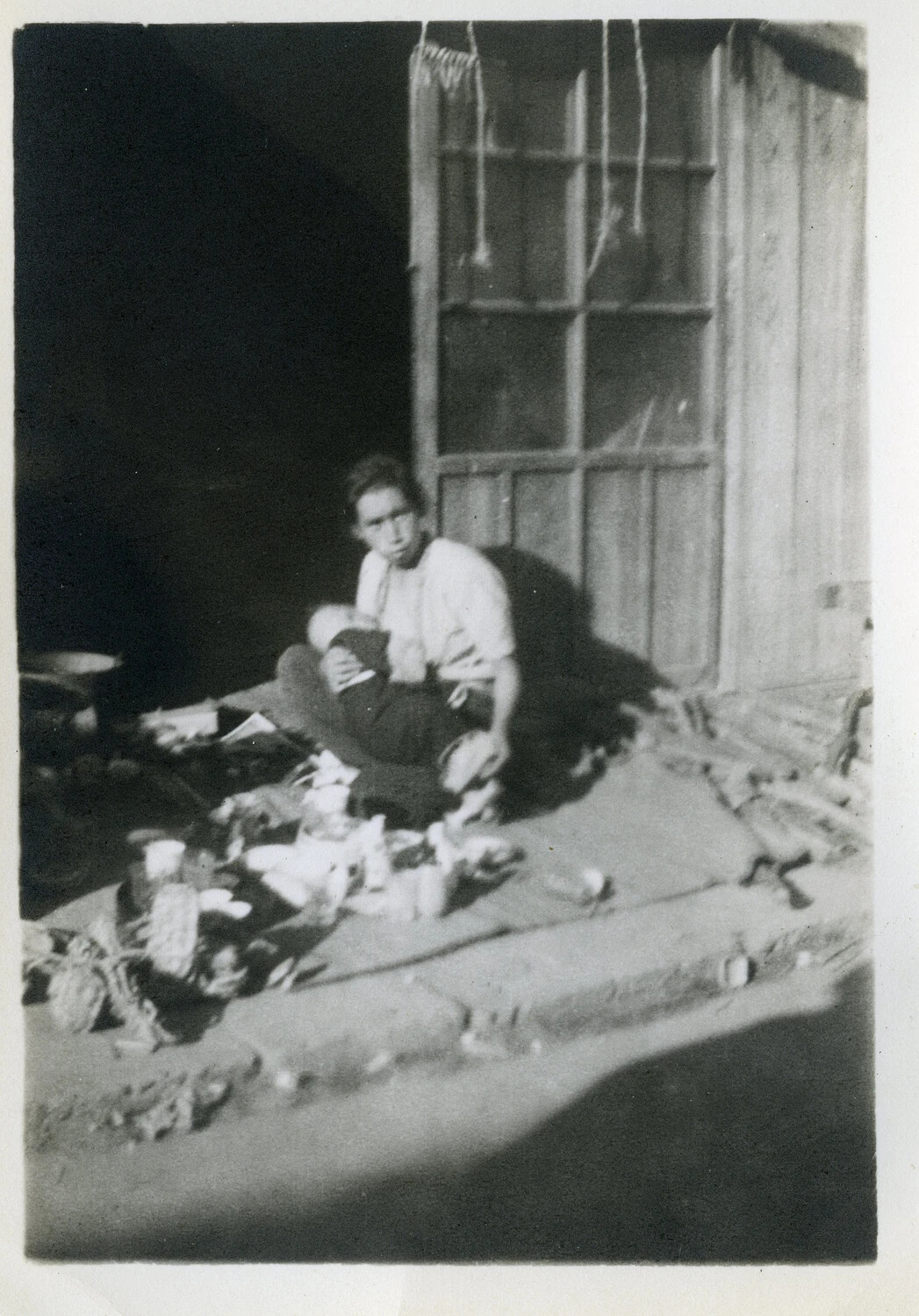 Woman with Infant Amid Household Goods, Occupied Japan, circa 1945-1946