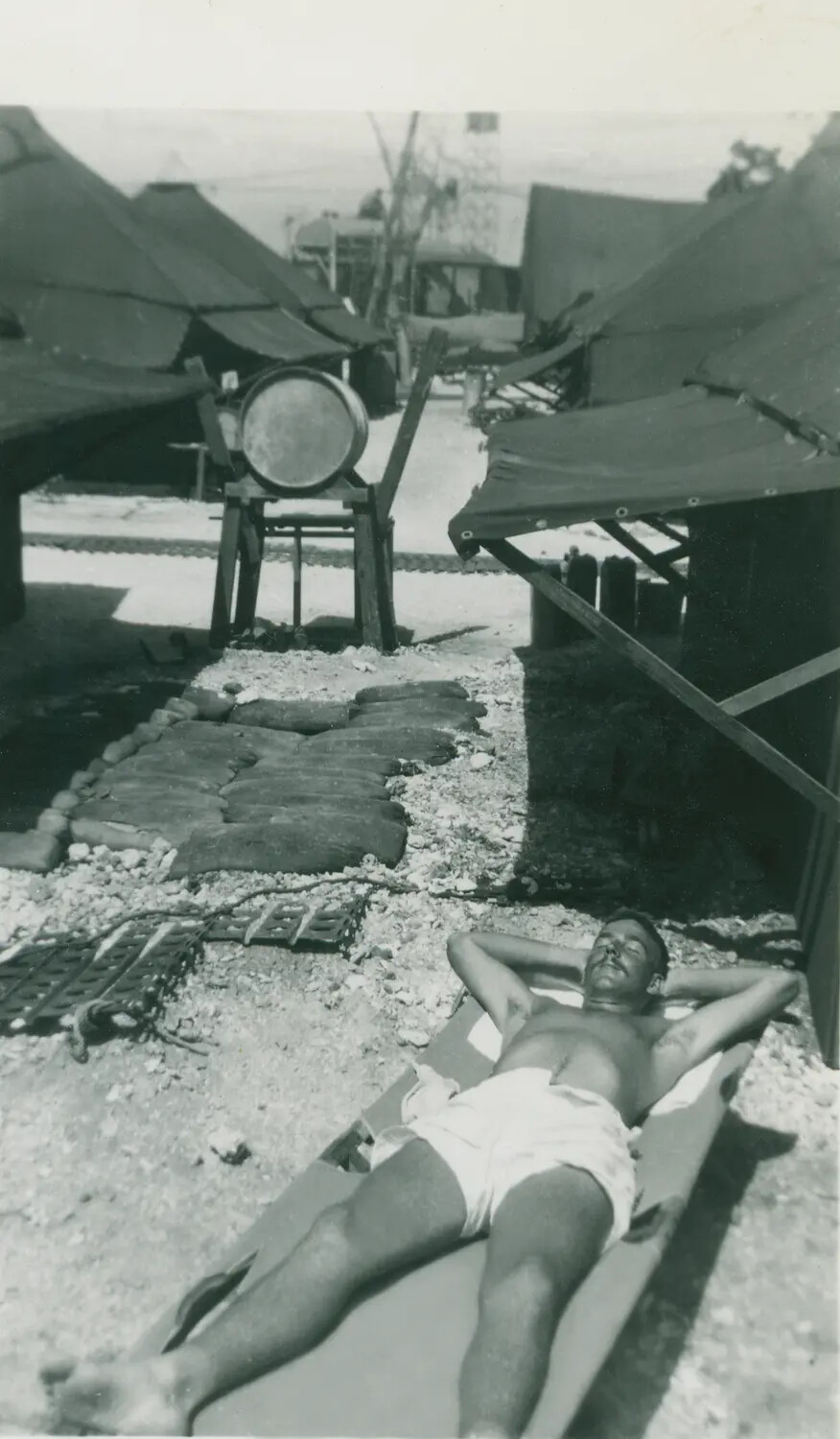 Serviceman Sunbathing at Pacific Island Airbase Camp, WWII