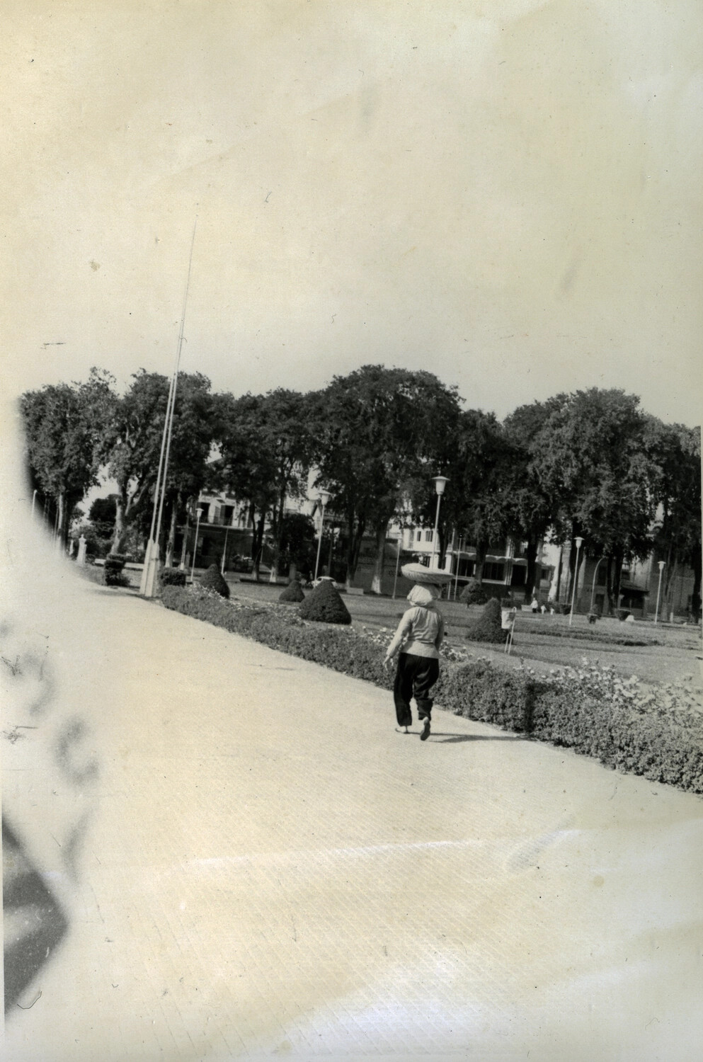Woman Carrying Basket on Head Along Park Walkway, Phnom Penh, Cambodia, c. 1960s