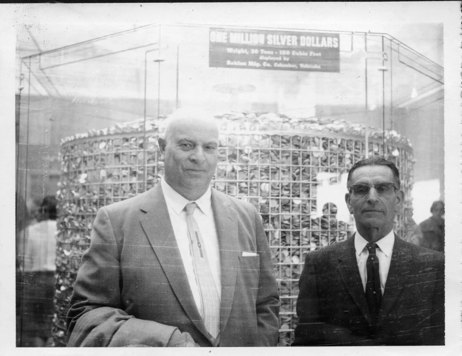 Two Men Posing Before a 'One Million Silver Dollars' Coin Display Exhibit, Presidio Album, c. 1950s-1960s