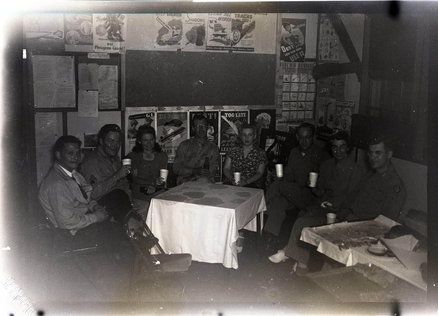 Informal Group Gathering in Barracks Dayroom with WWII Safety Posters