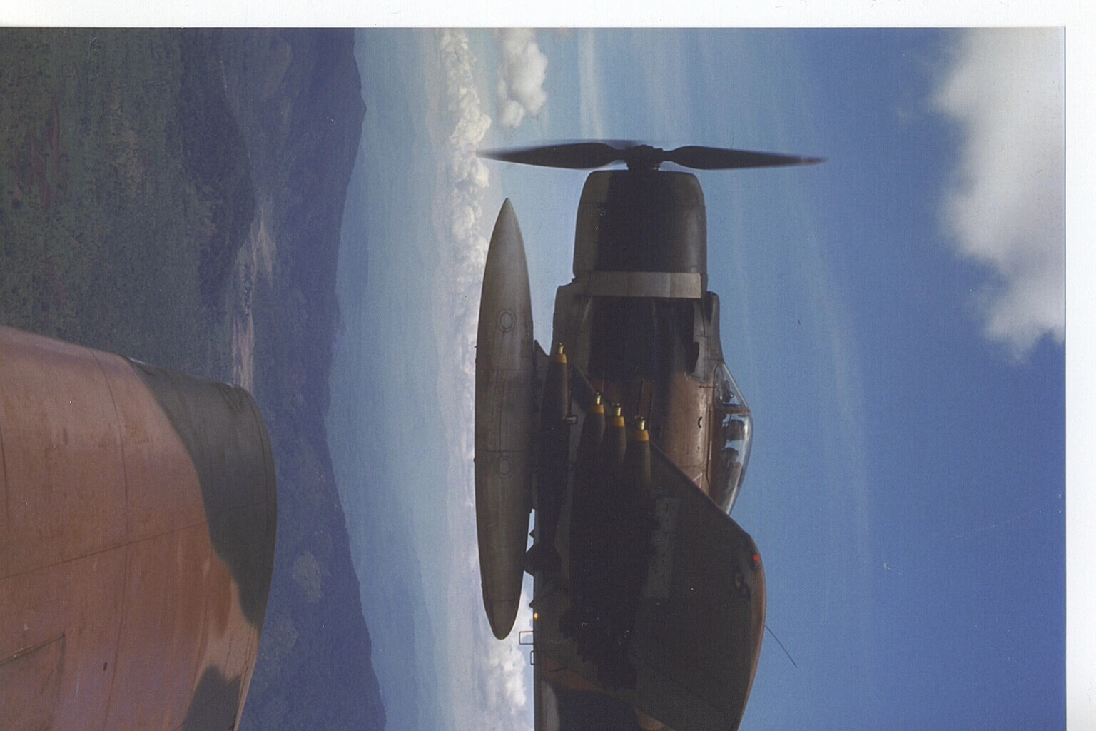 Air-to-Air Photograph of A-1 Skyraider in Banking Flight with Ordnance Load, 6th SOS