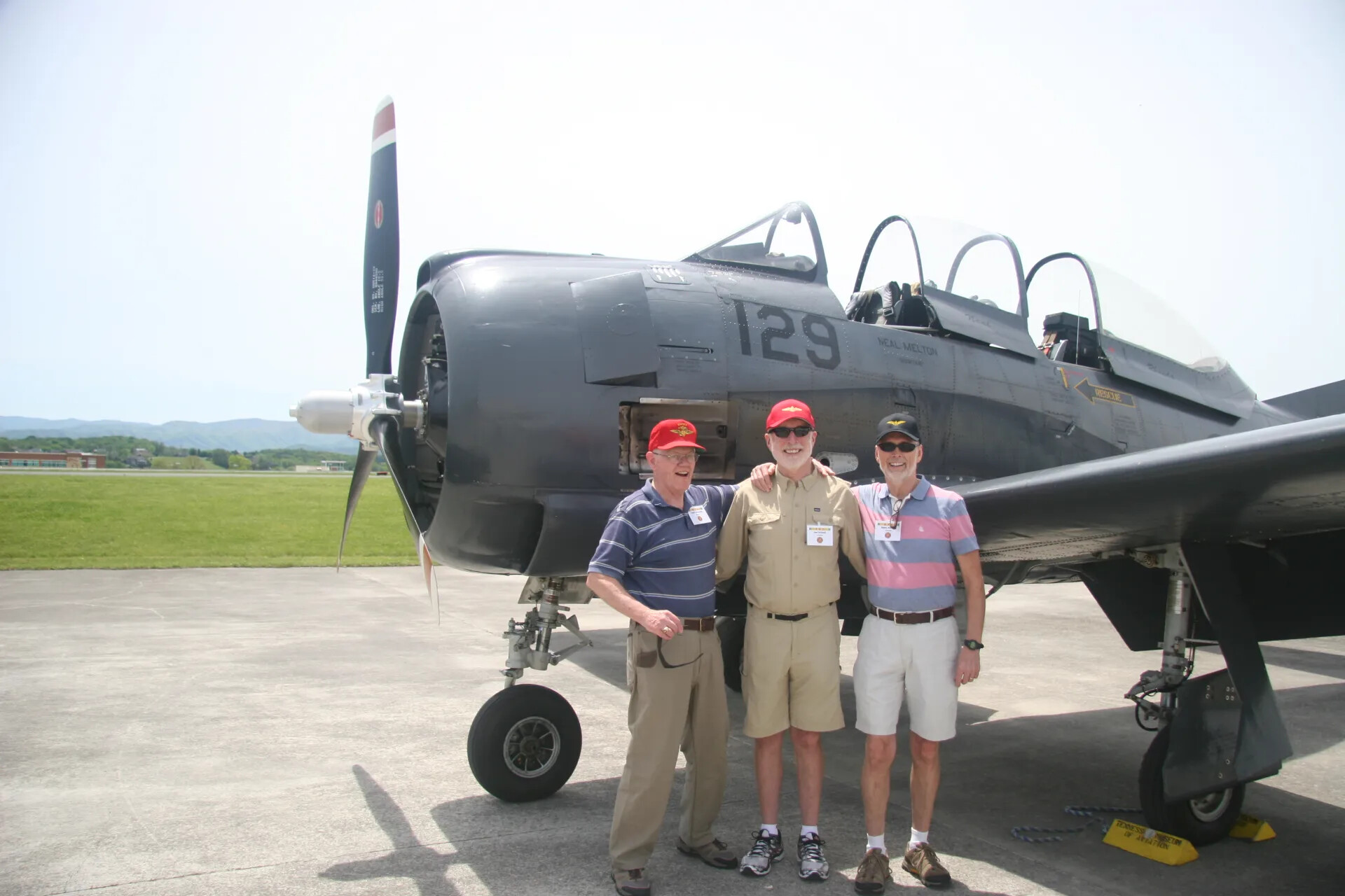 Veterans Posing with Trainer/Attack Aircraft "129" (Neal Melton) at Tailwind Day Reunion, 2016