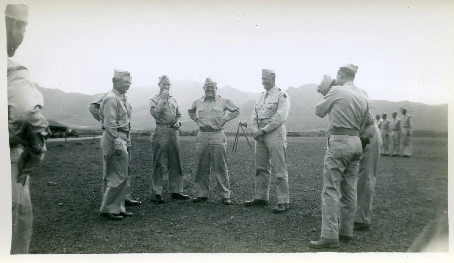 Officers Gathered Around Surveying Instrument on Training Field