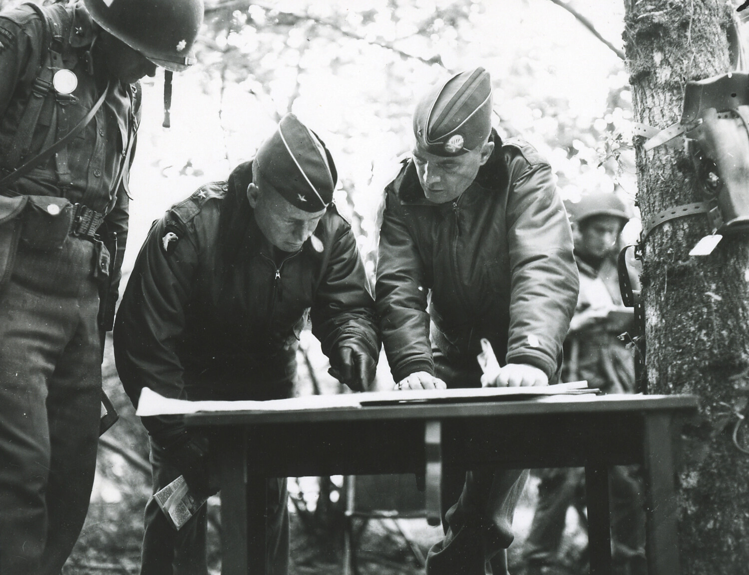 U.S. Army General Officer Reviewing a Map at a Field Table in the Woods, Bastogne Area, Belgium, December 1944