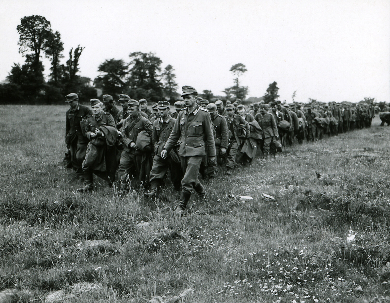 Column of German Prisoners of War Marching Under Guard, Normandy, France, June-July 1944
